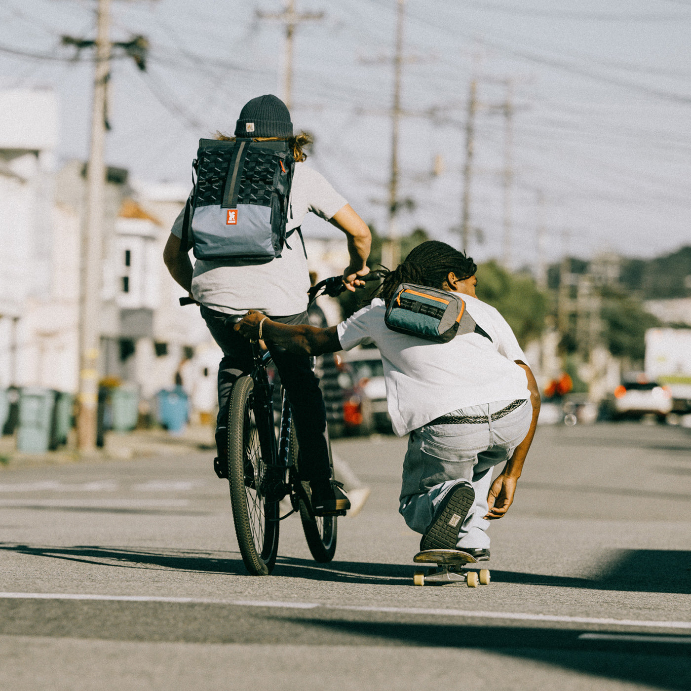 person on a skateboard wearing a Chrome sling bag