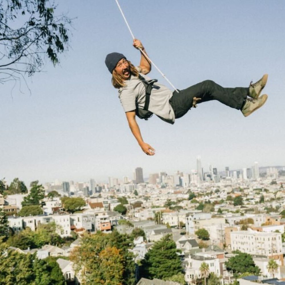 A dad jumping in the air wearing a Chrome bag