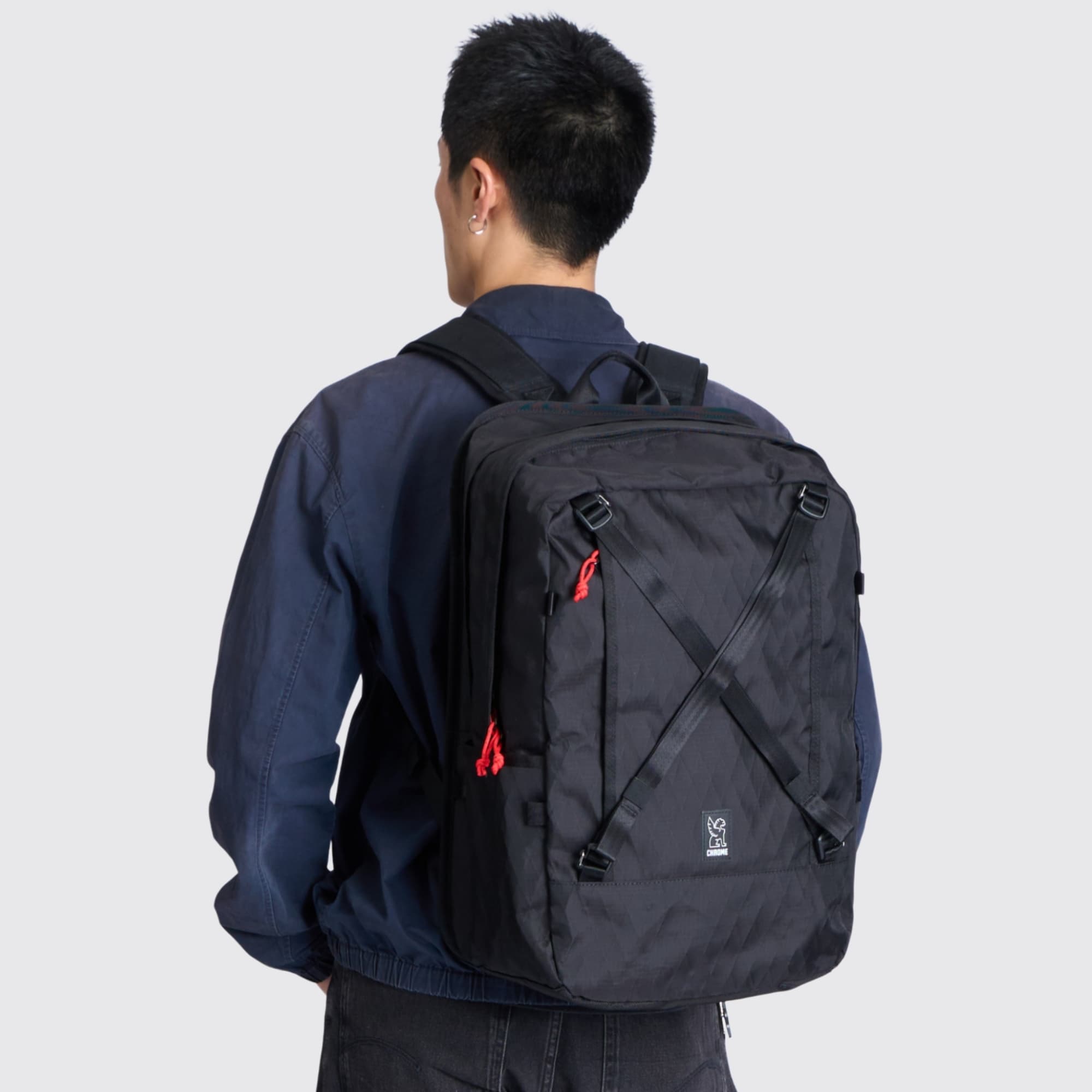 A man wearing the Cohesive 38L Pack on his back