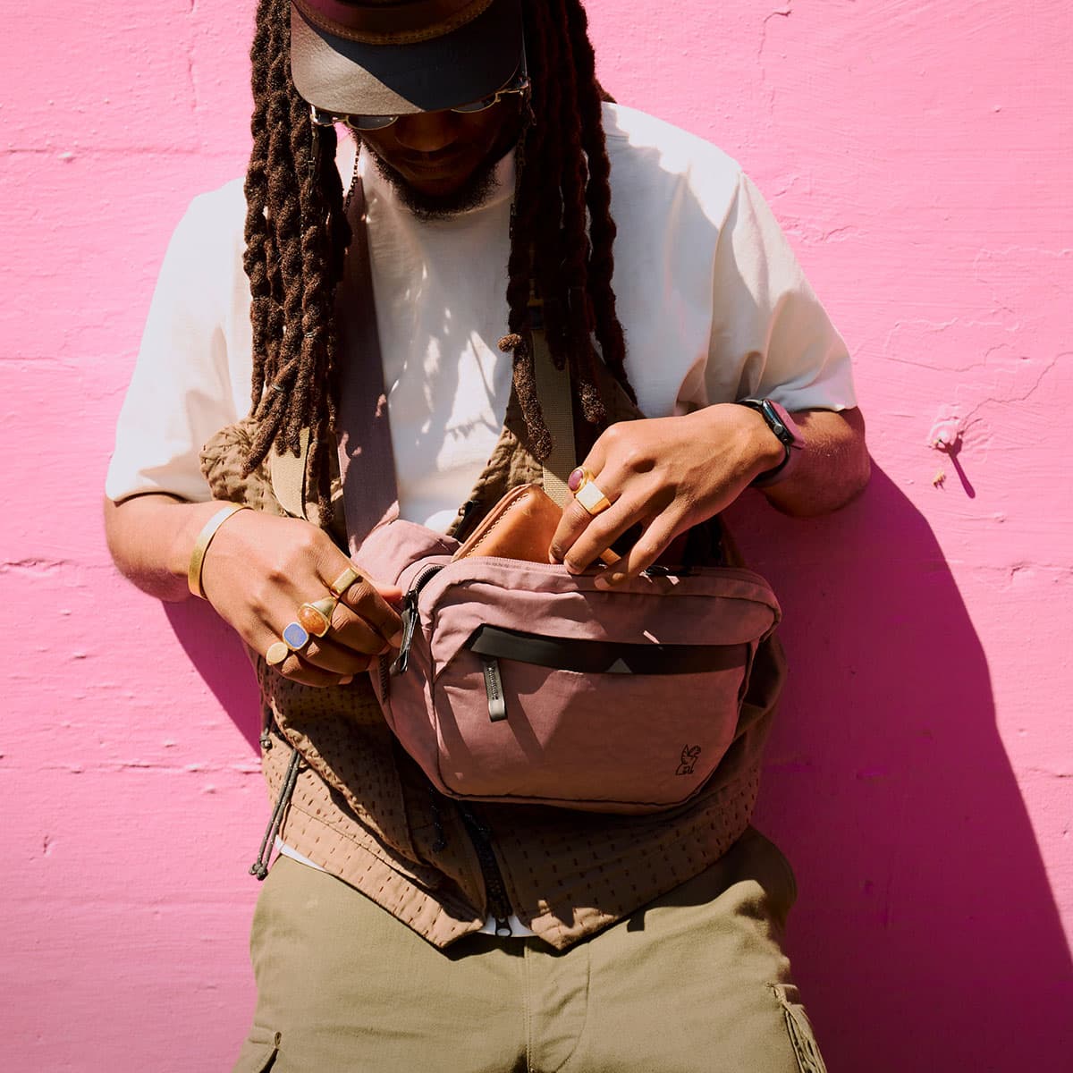 A guy with dreadlocks holding the Sabin 6L Sling