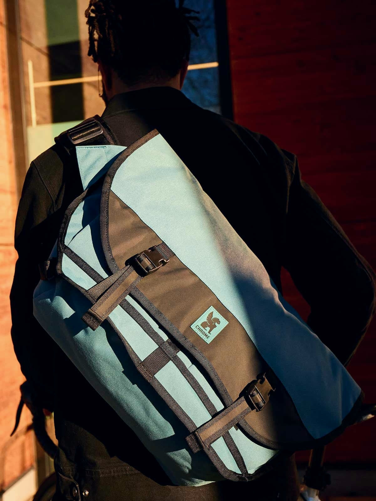 A close up of a guy carrying the Citizen Messenger in Steel Blue