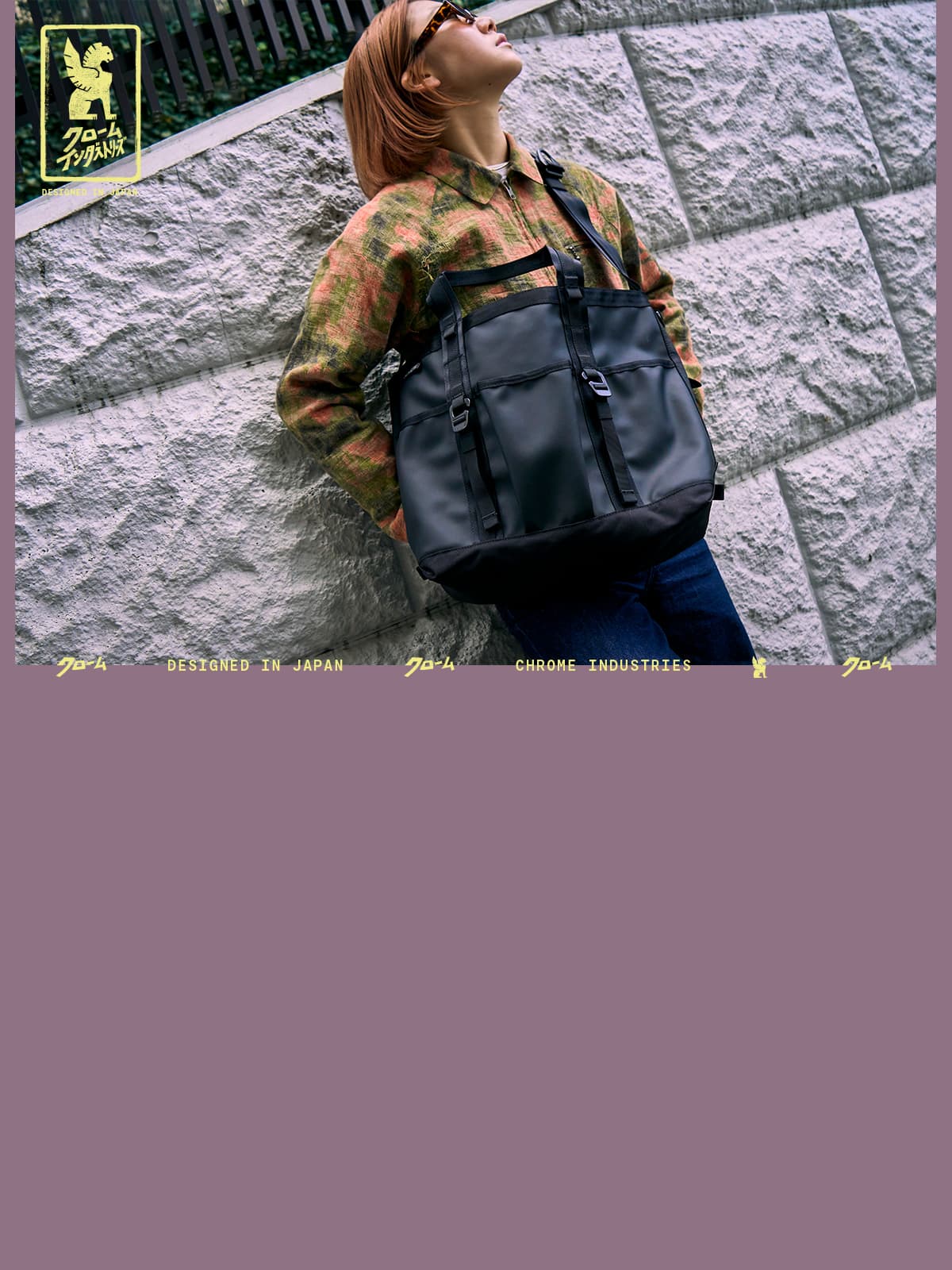 A woman wearing the Grocery Tote in Tokyo leaning on a wall