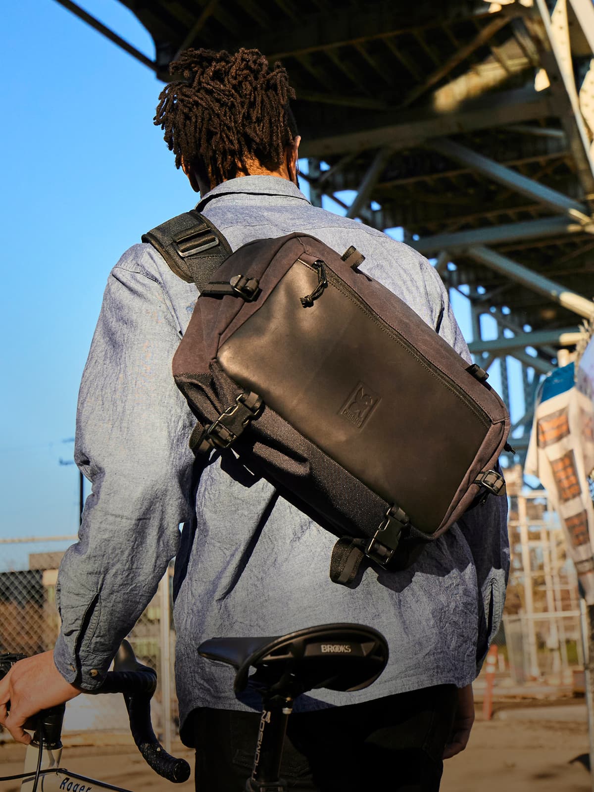 The Kadet Max in Black Leather on a guy walking his bike