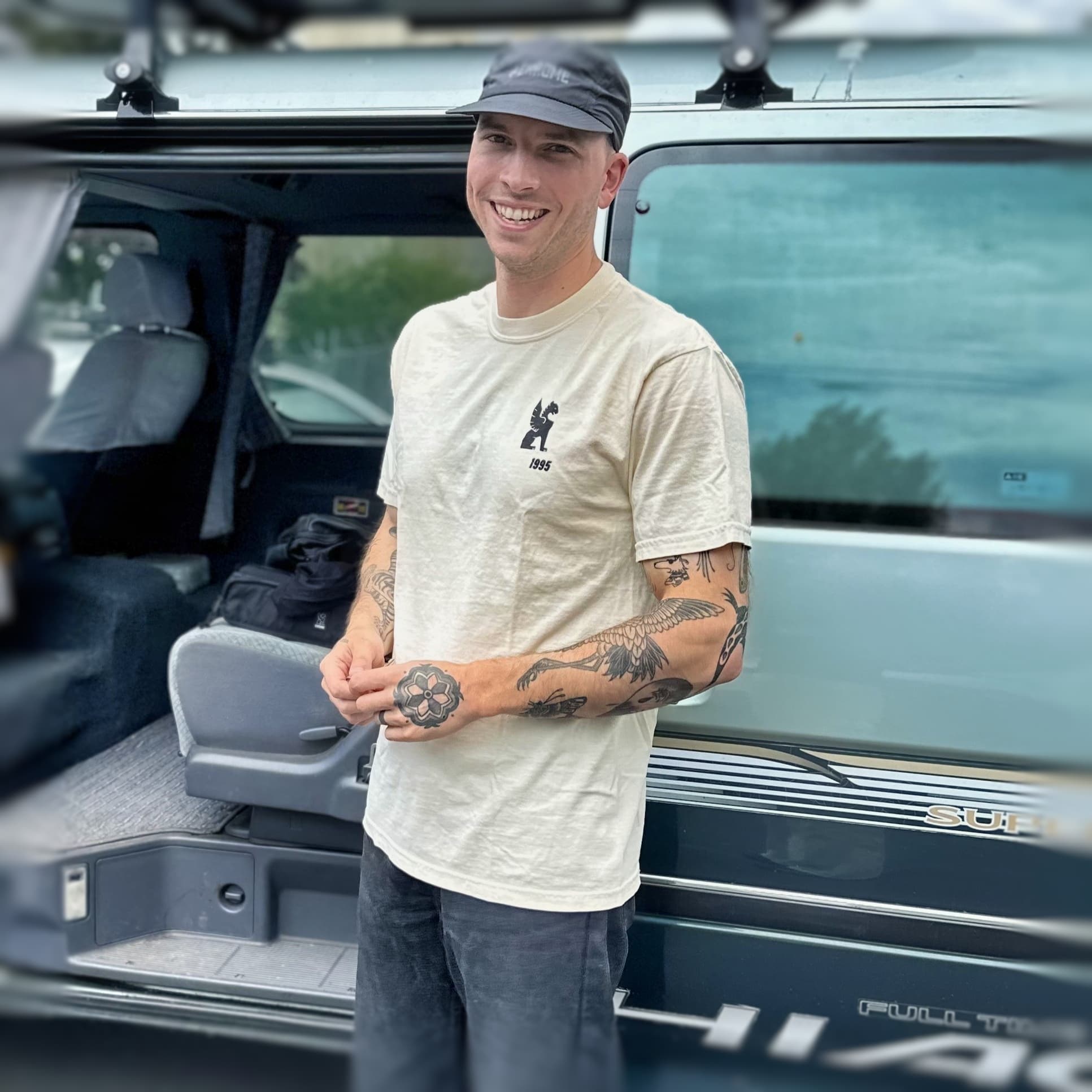 Guy wearing the 30th anniversary Tee front logo in future white