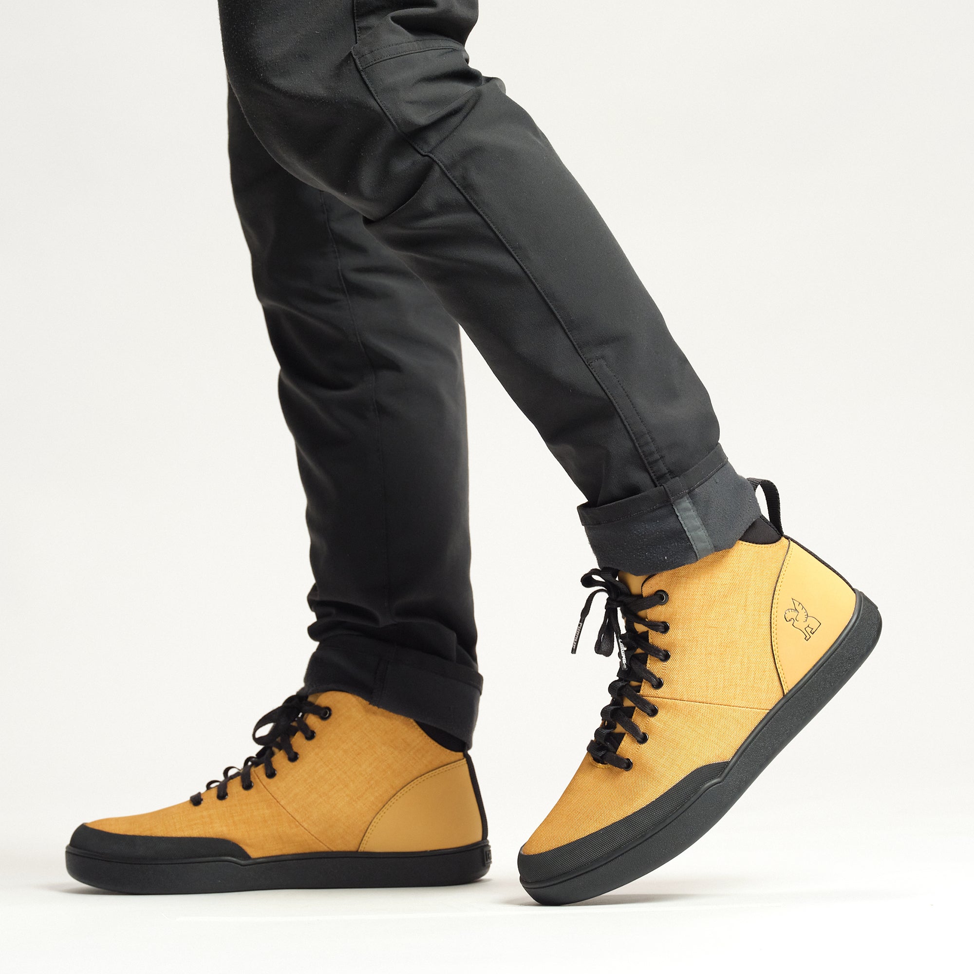 Bromley mid sneaker in wheat on a person #color_wheat black