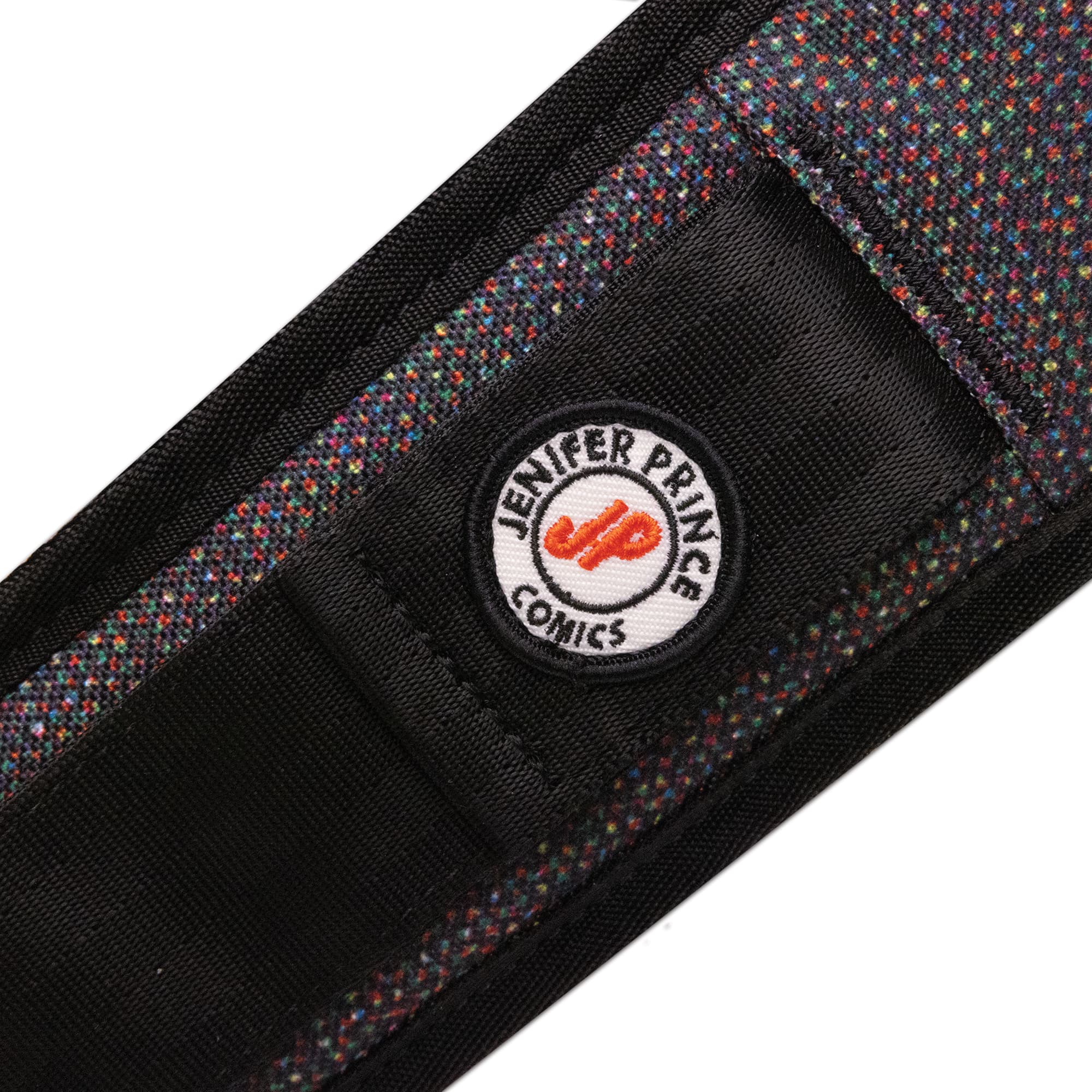 The patch on the strap of the J Prince Mini Kadet Pride bag #color_j prince