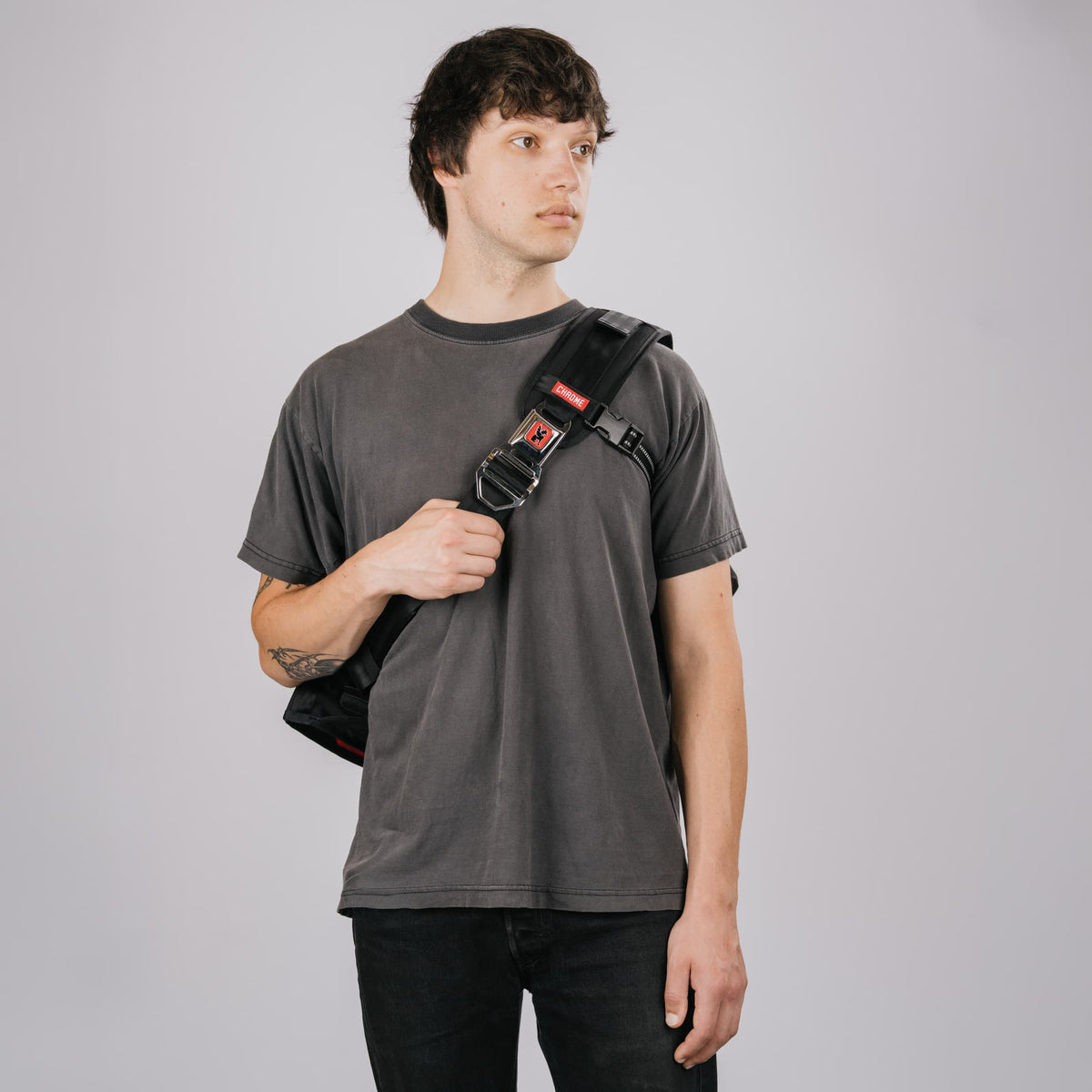 The Citizen 24L Messenger in new Classic Black White on the front of a guy #color_classic / black / white