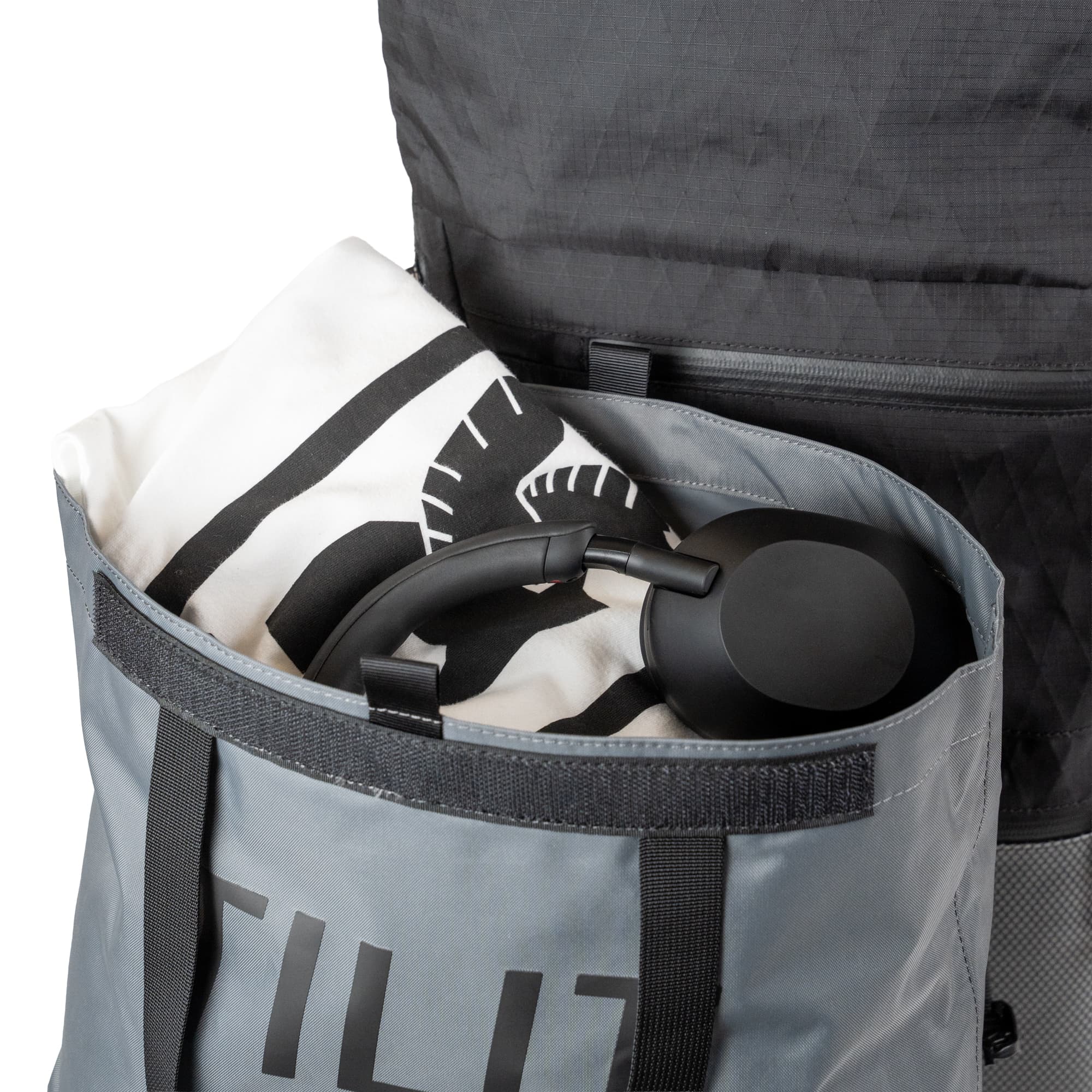 The removable tote packed up with a Tee and headphones at the top