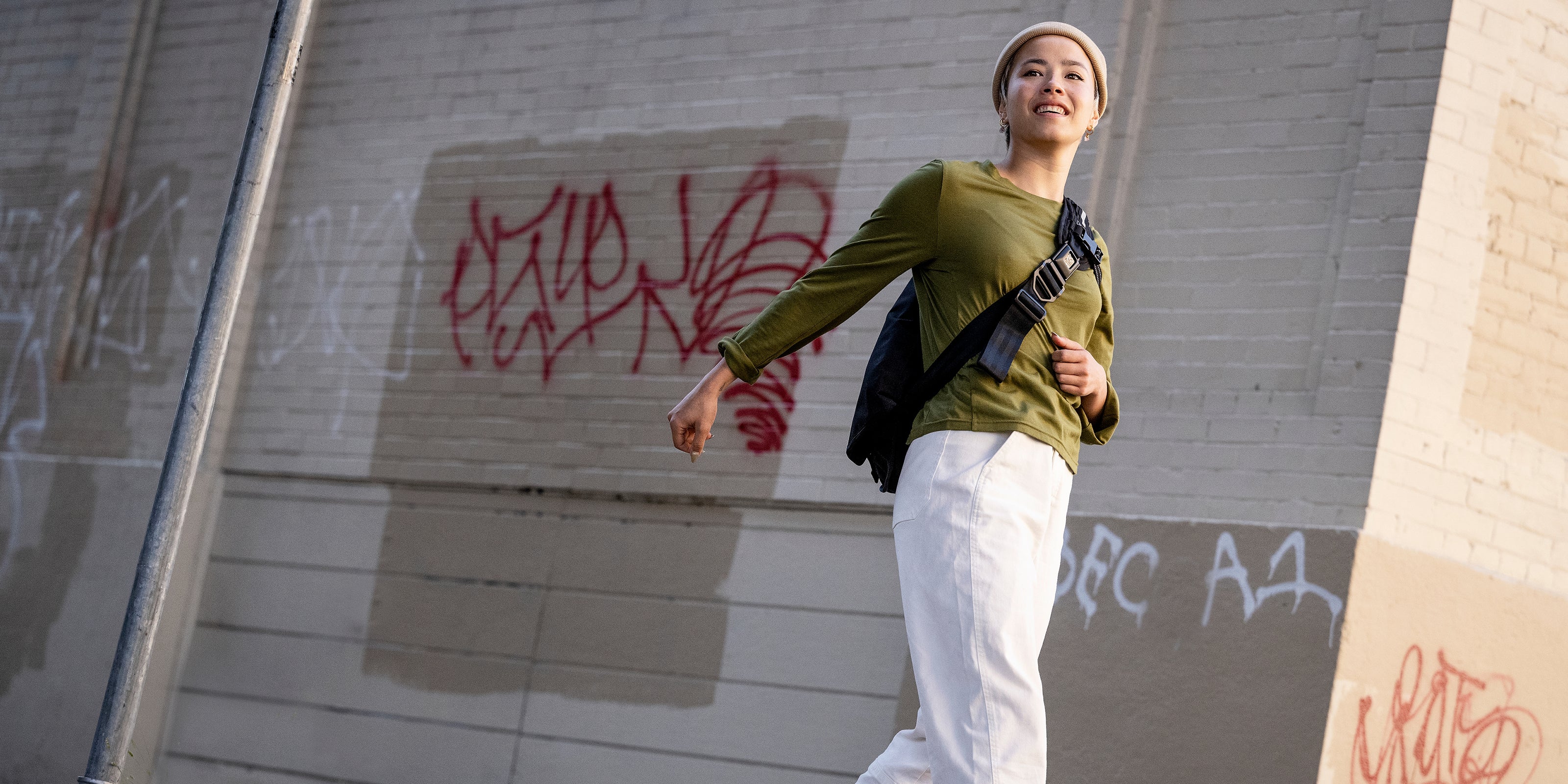 Women's Chrome Issued Long Sleeve Tee in green worn by a woman walking desktop size image