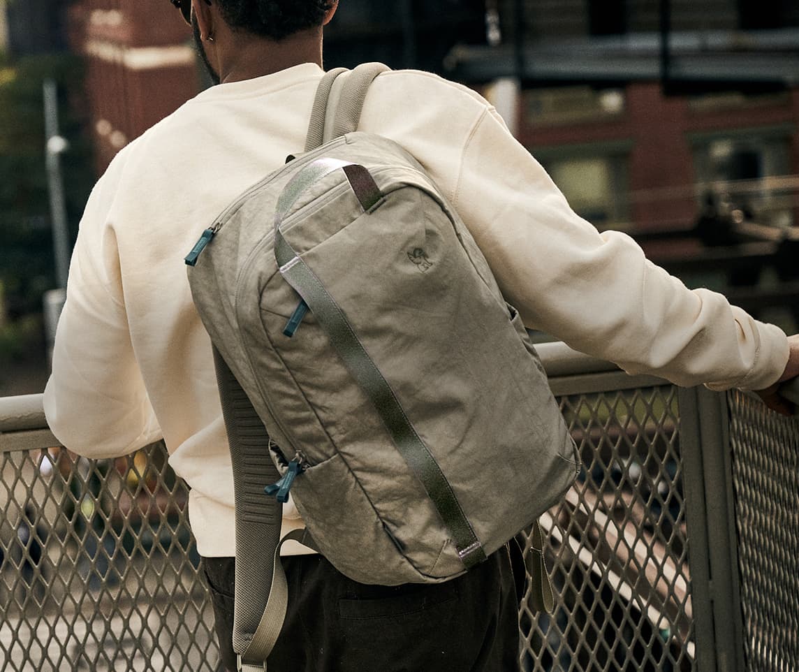Man wearing the Highline backpack traveling