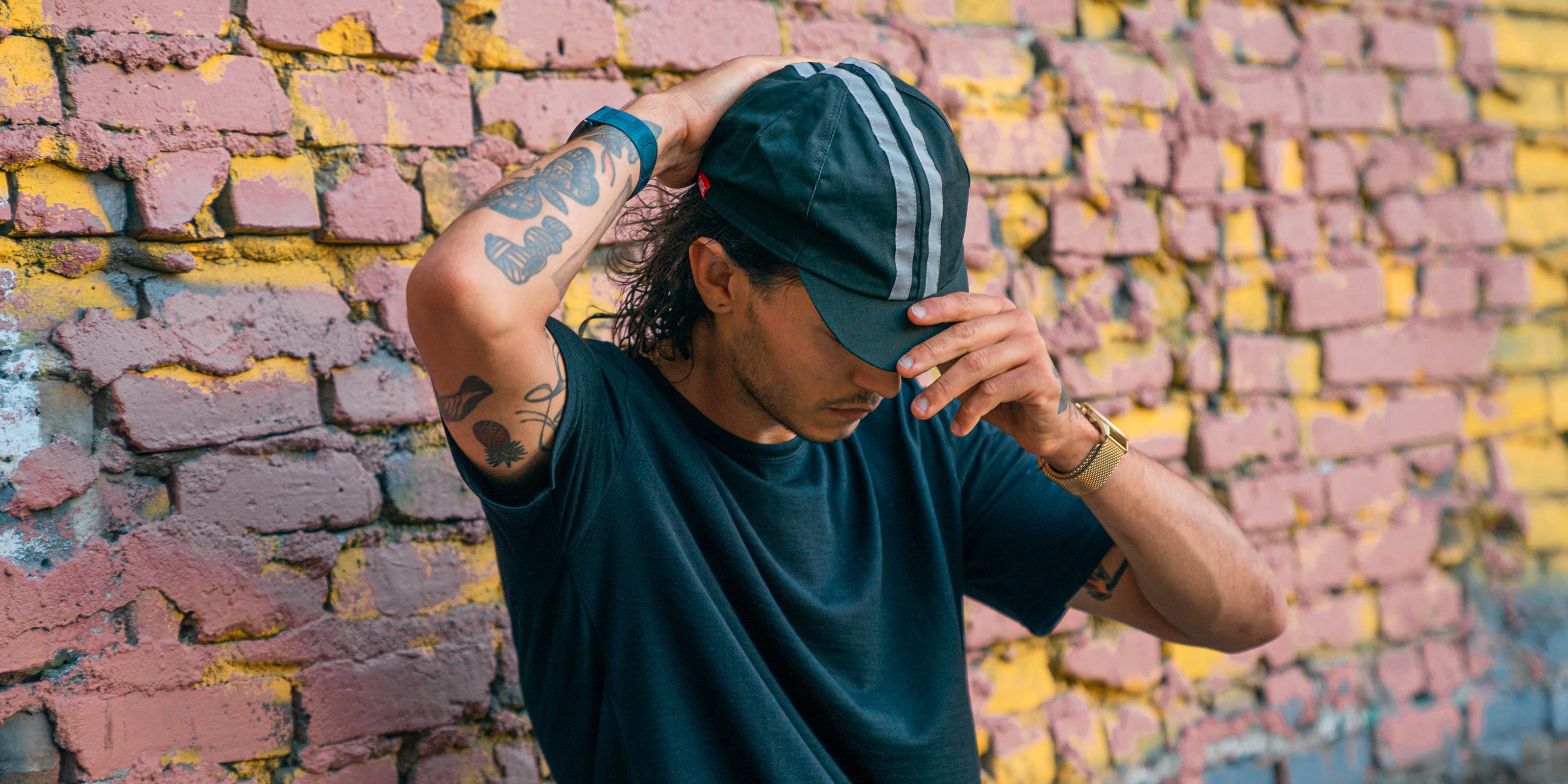Cycling cap on a guy holding the brim desktop size