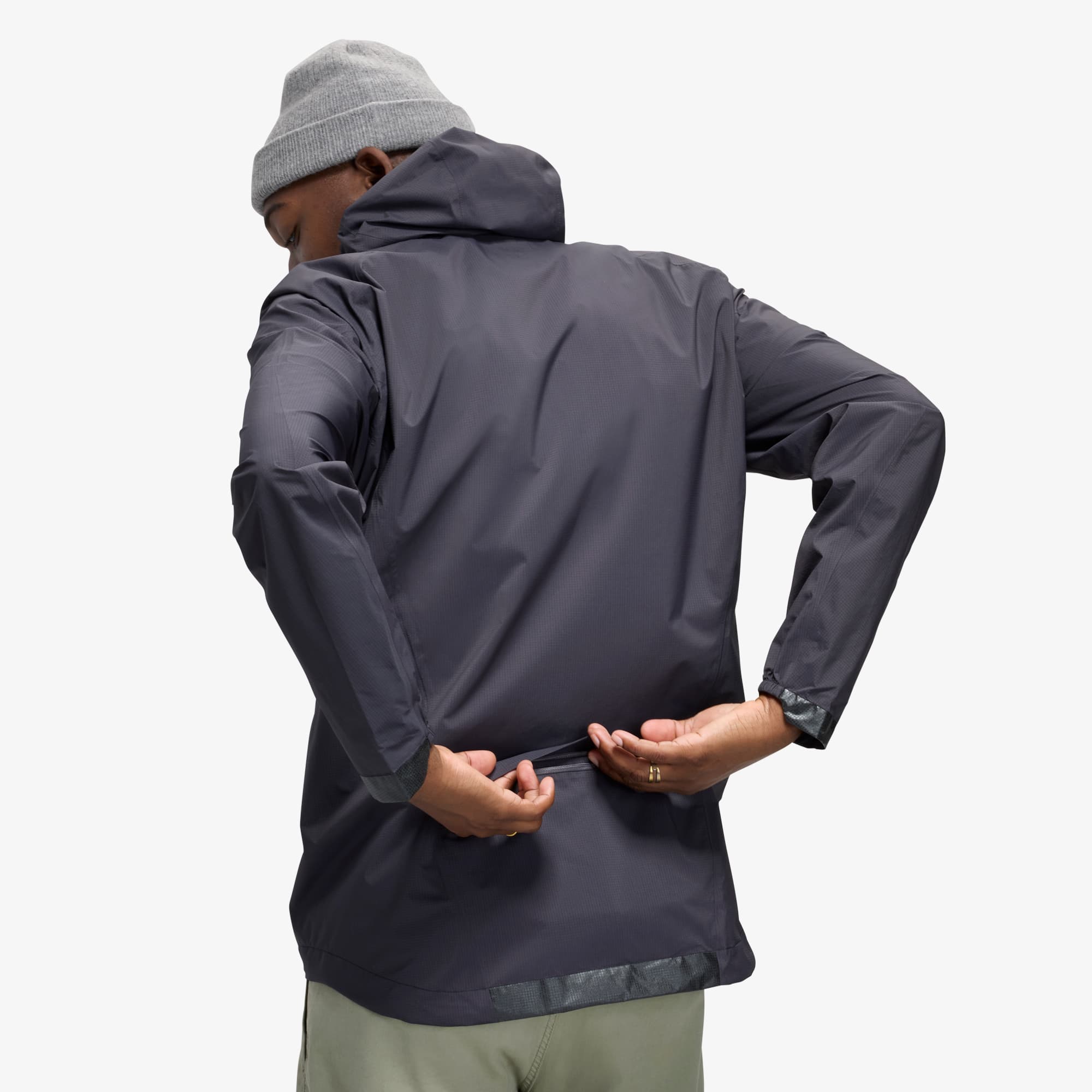 Unzipping the back of the Downpour Jacket pocket