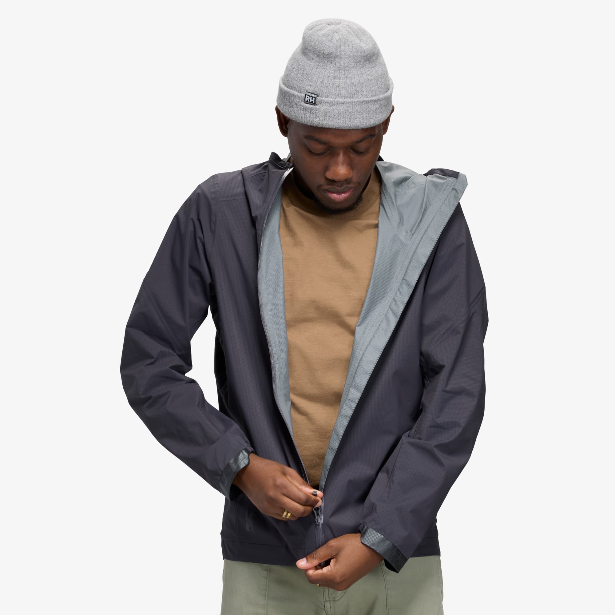 Zipping up the Downpour Jacket in black