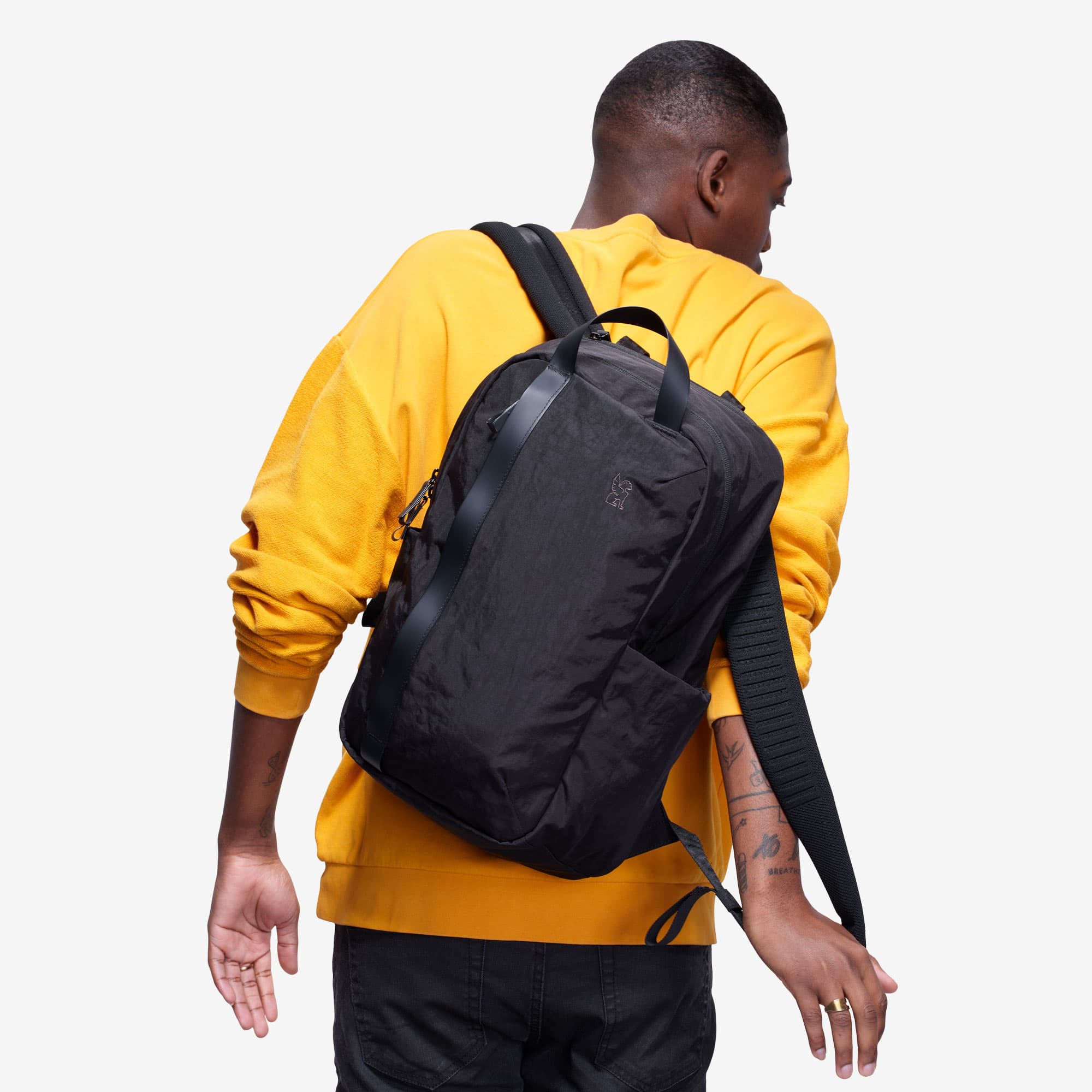 Man putting on the Highline backpack