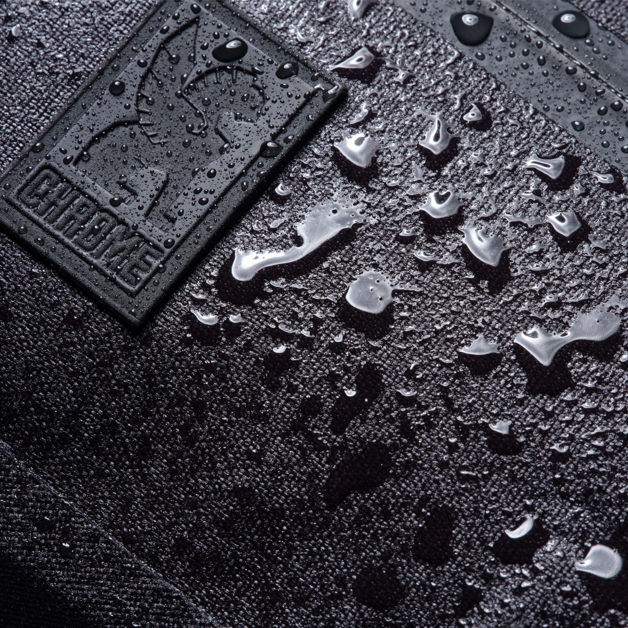 Water drops around the logo of the waterproof Mini Kadet #color_black