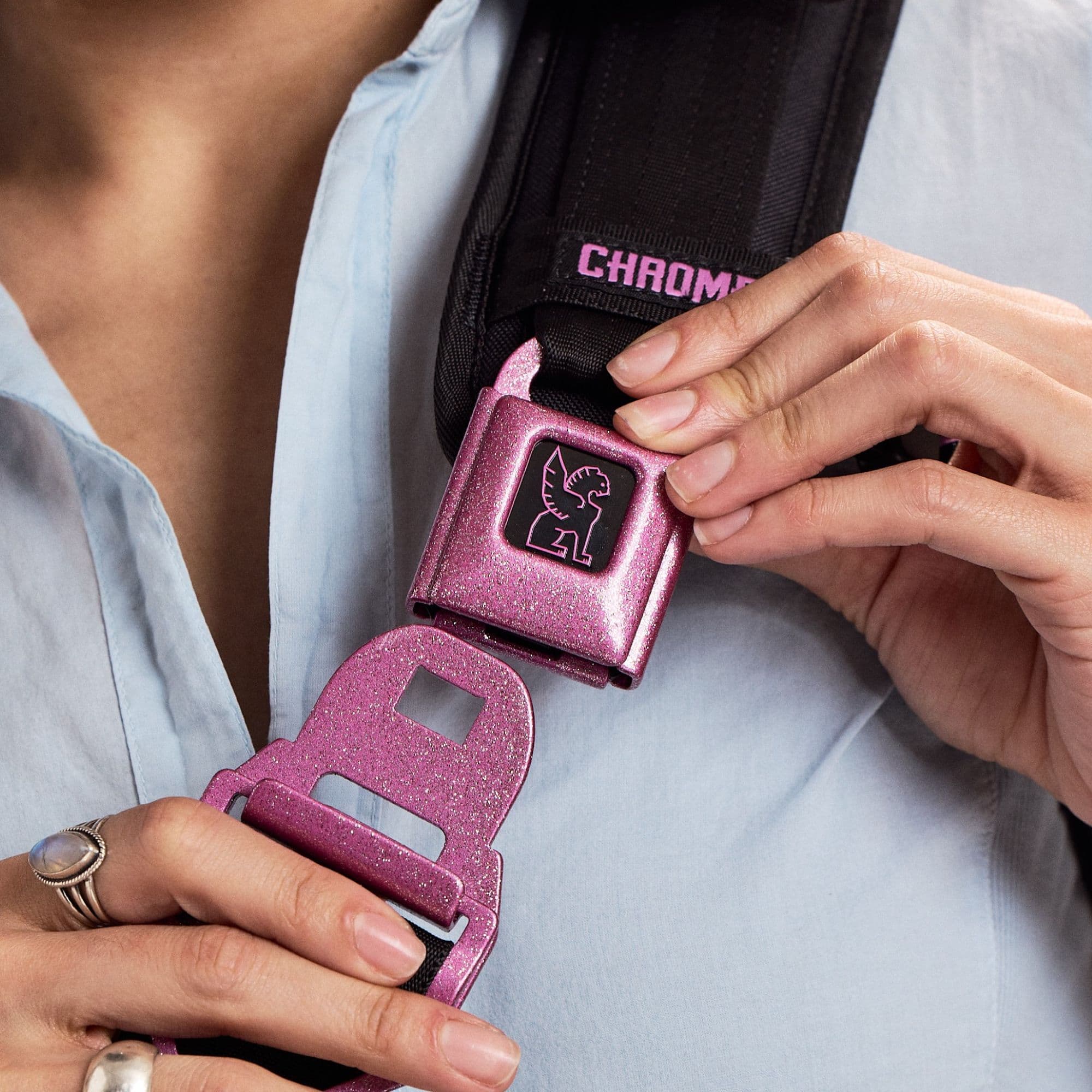 Large Seatbelt Buckle in Pink Glitter opened by a woman #color_pink glitter