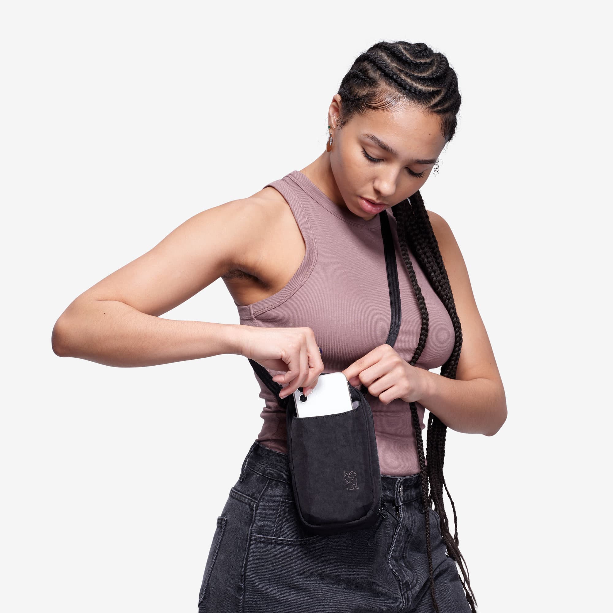 Logan pouch worn by a woman adding her phone