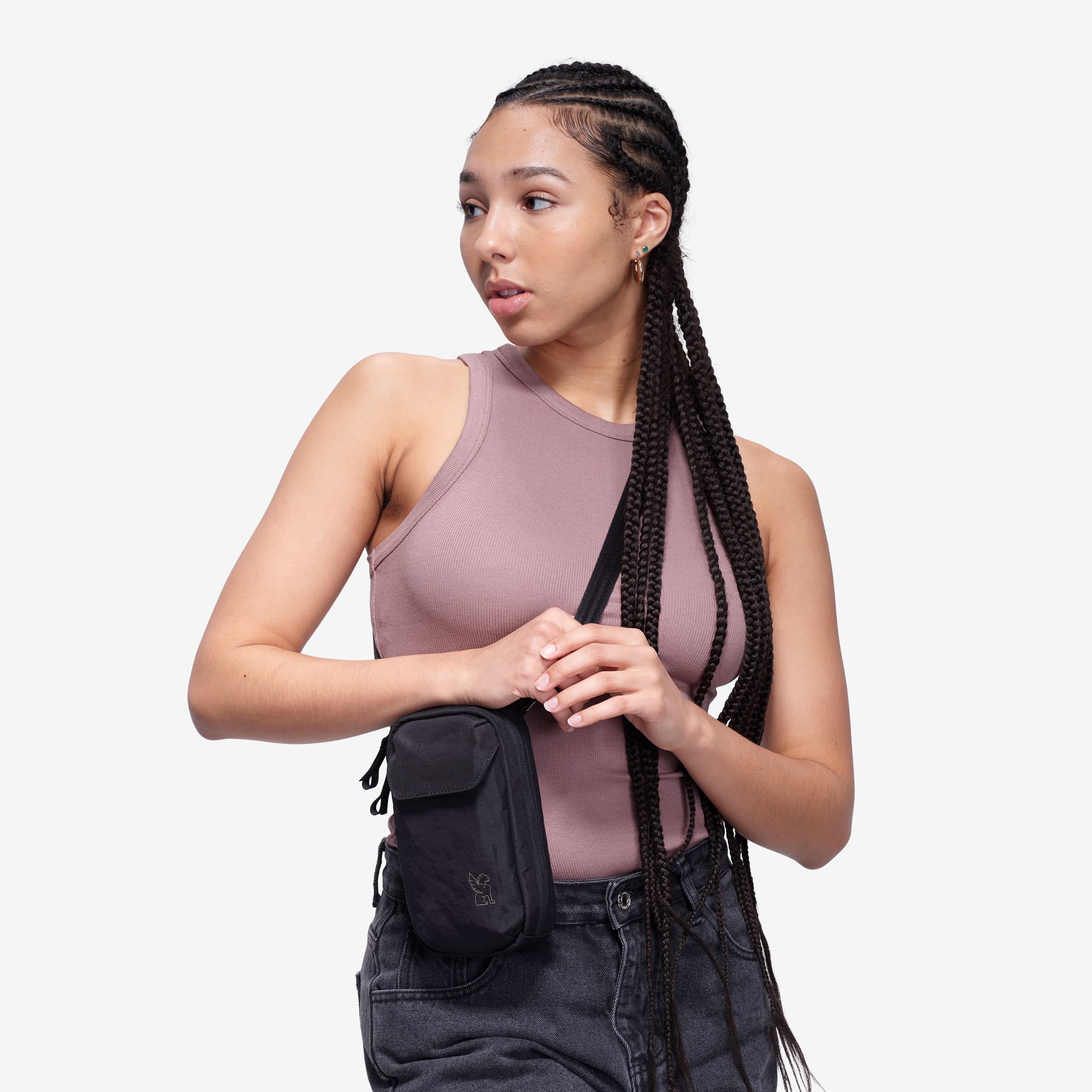 Logan pouch on a woman holding the strap #color_black