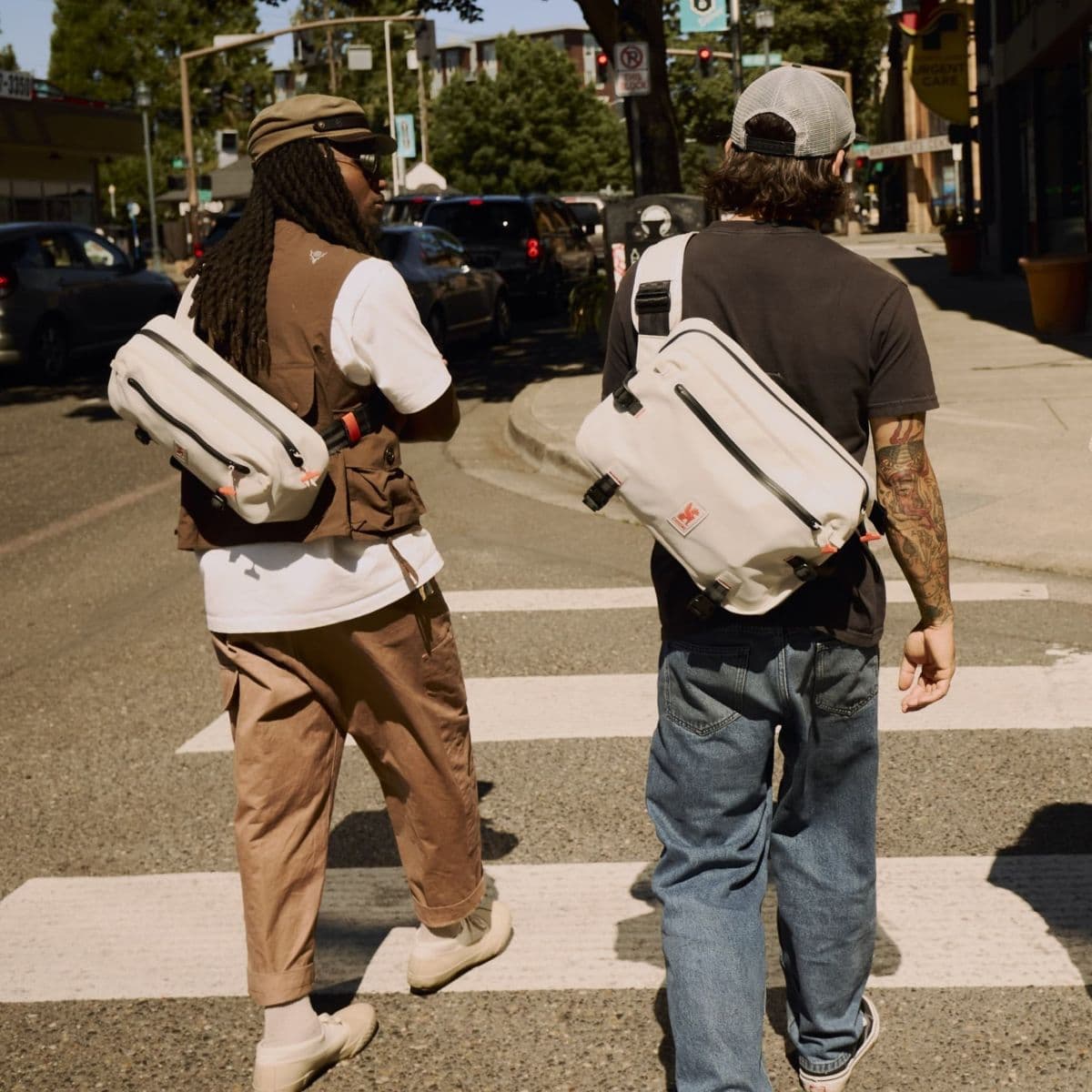 Two people crossing a street with waterproof Kadet slings.
