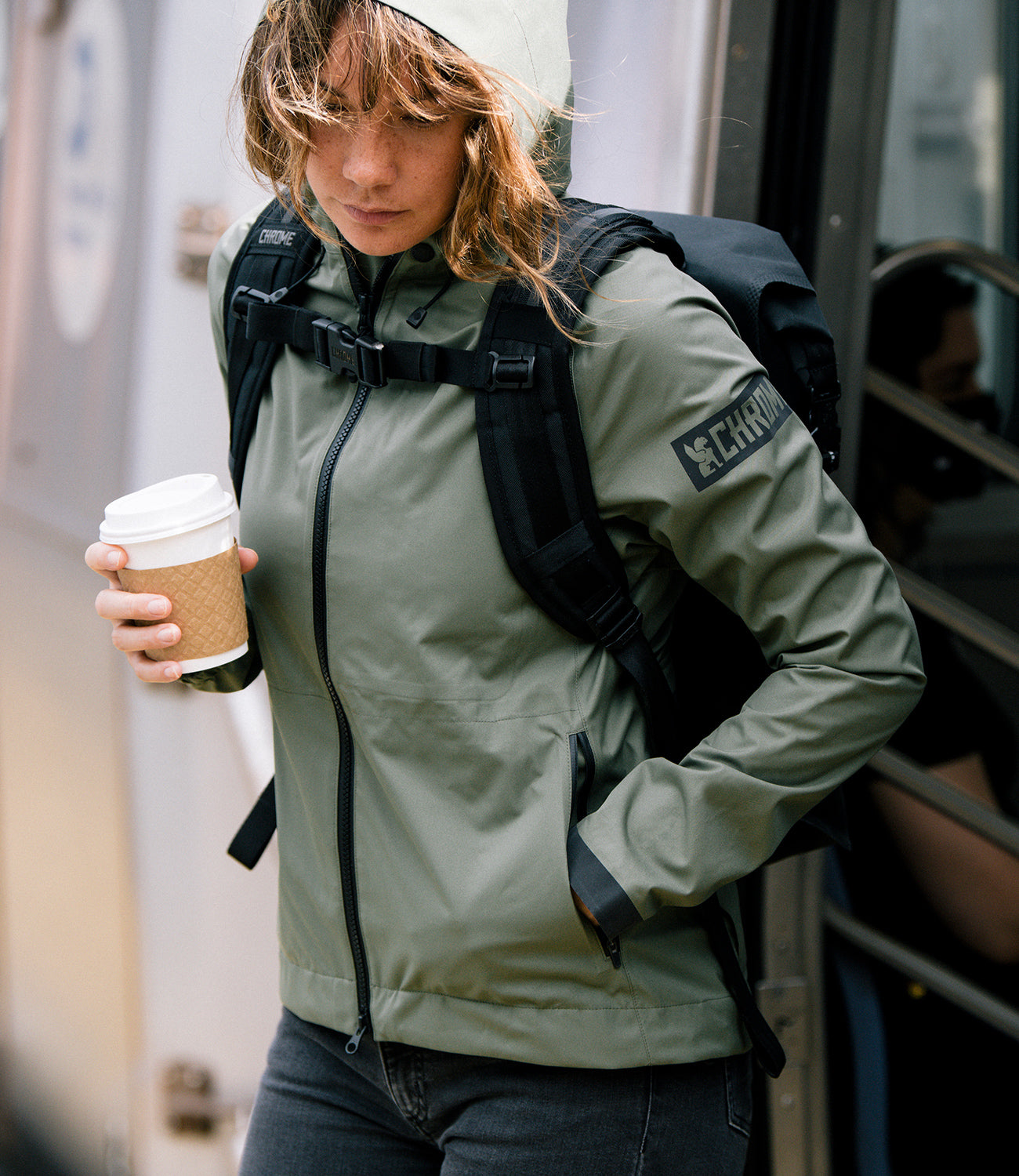 Woman's Storm Salute Commute Jacket in green worn by a woman mobile size 