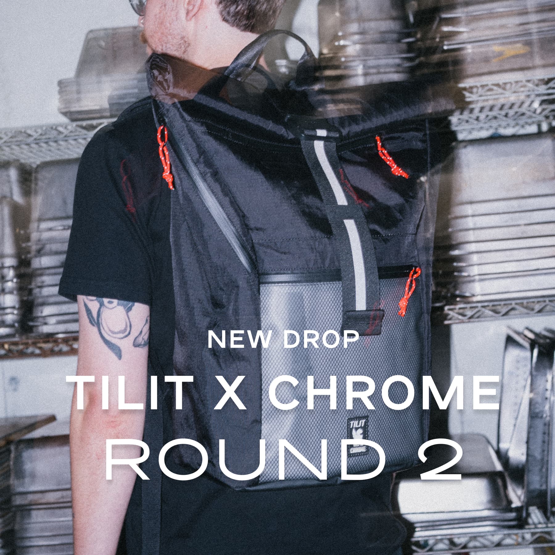 Person wearing a black backpack with 'TILIT X CHROME' logo in a kitchen.
