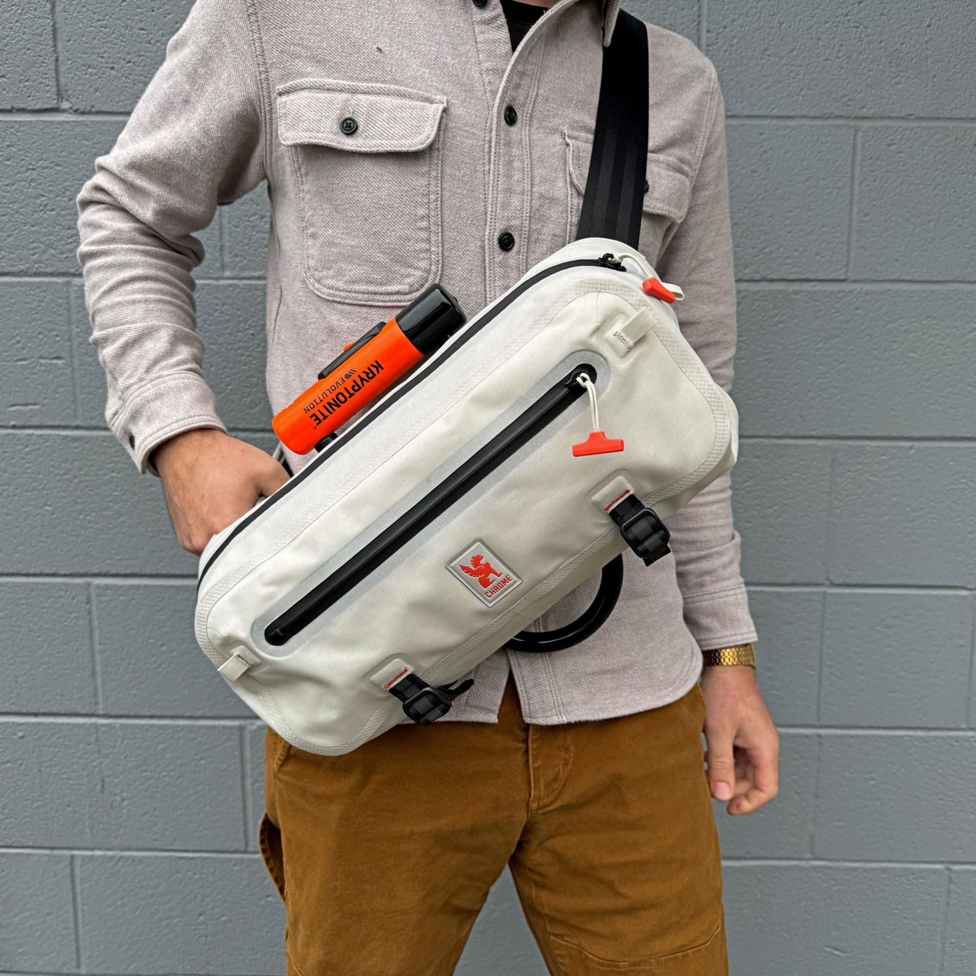 Person holding a Waterproof Kadet against a gray brick wall #color_future white