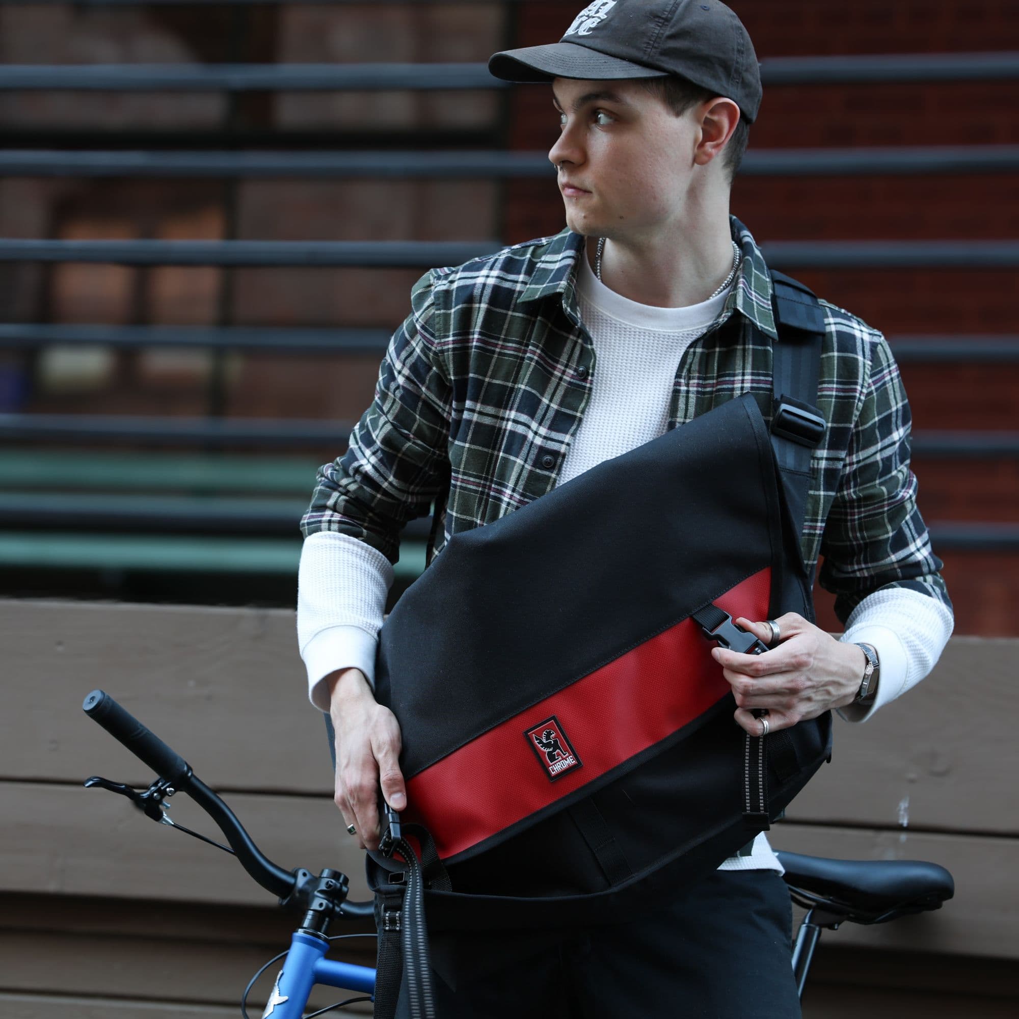 A guy opening the Metropolis Messenger on his bike