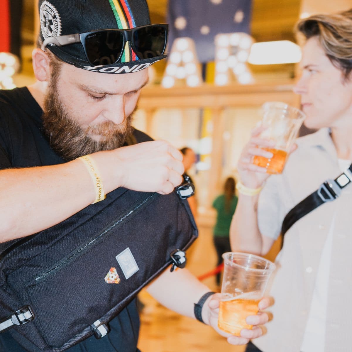A person opening a Kadet Sling at a World Cup Watch Party