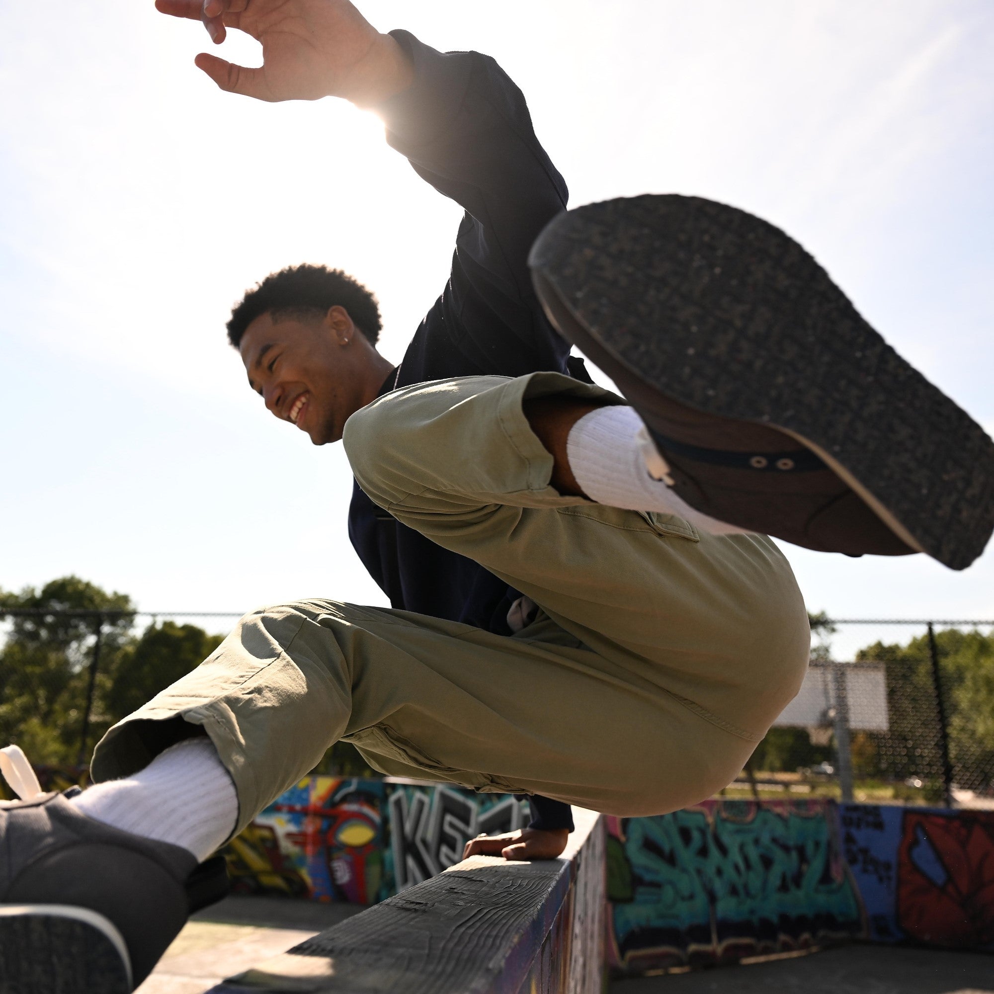 Powell sneaker on a guy jumping over a wall #color_castle rock