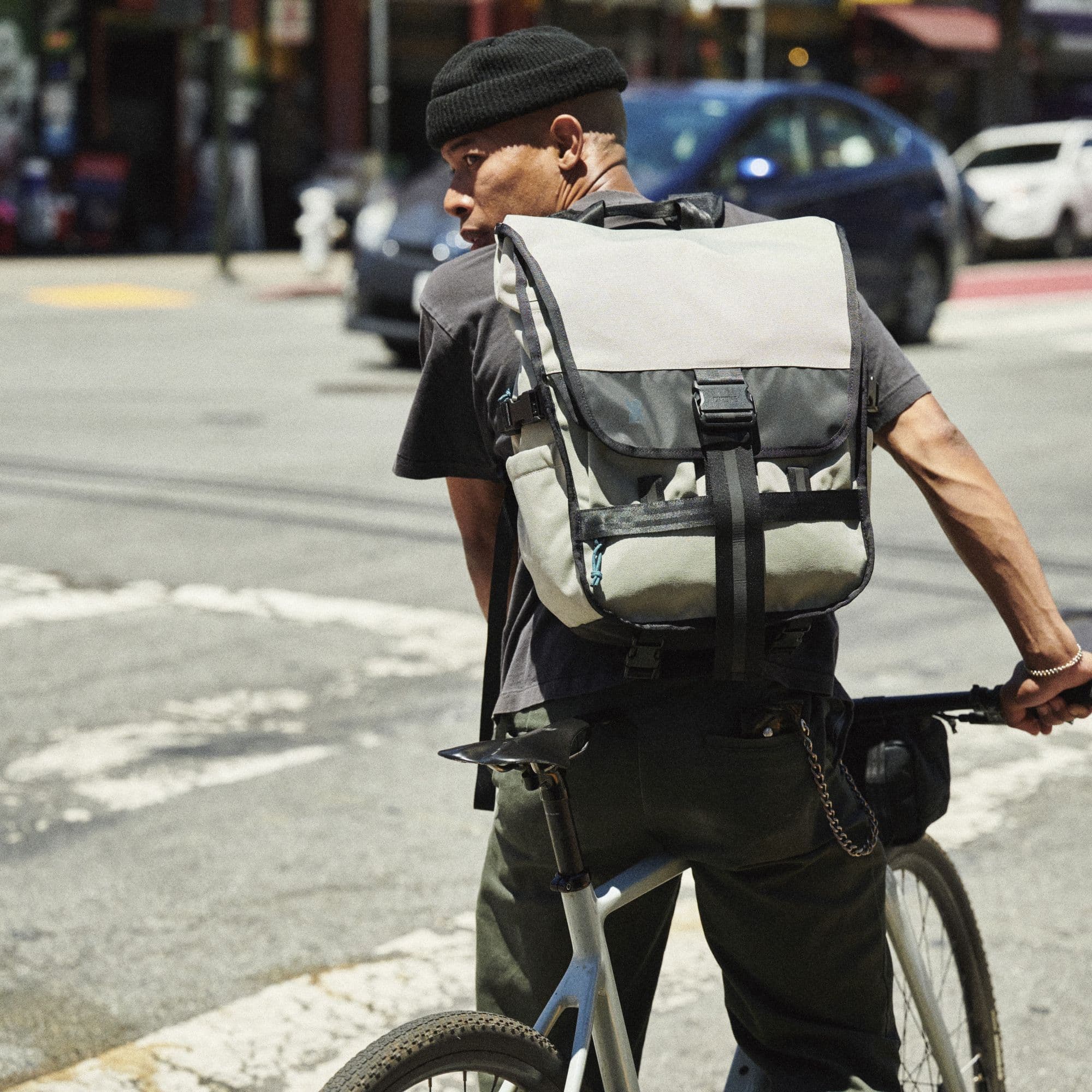 A guy riding a bike with the Warsaw Pack