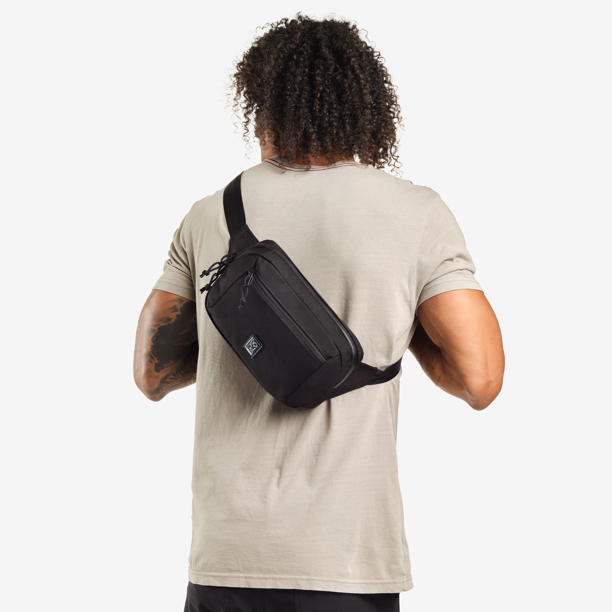 Ziptop Waistpack sling in black worn by a man