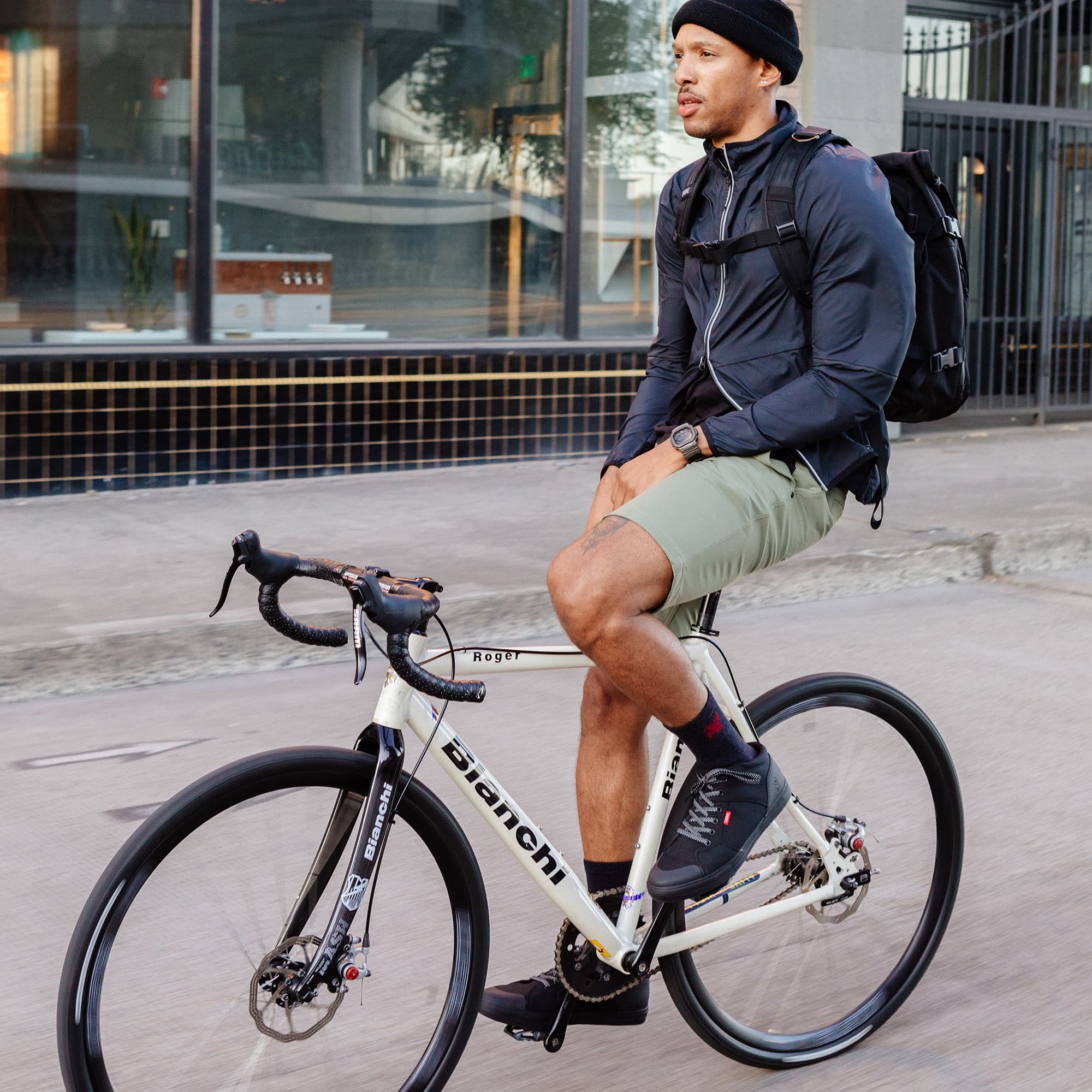 Man on a bike wearing the Southside high top sneaker in black