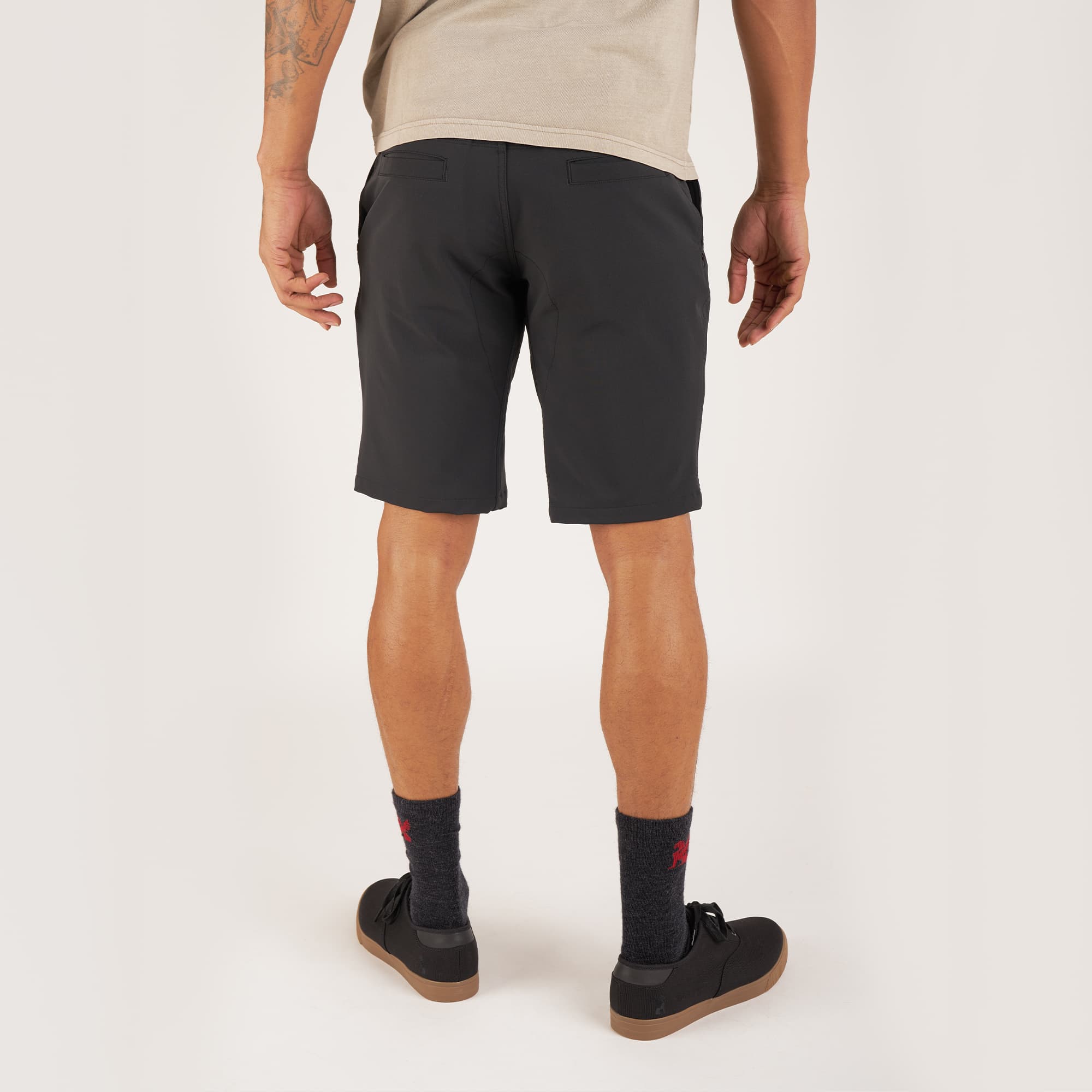 Men's Folsom tech biking Short in black worn by a man back view #color_black