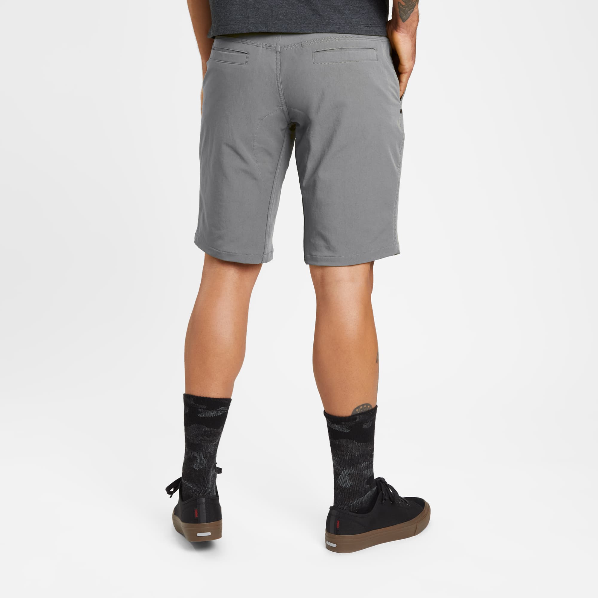 Men's Folsom tech biking Short in grey worn by a man back view #color_castle rock