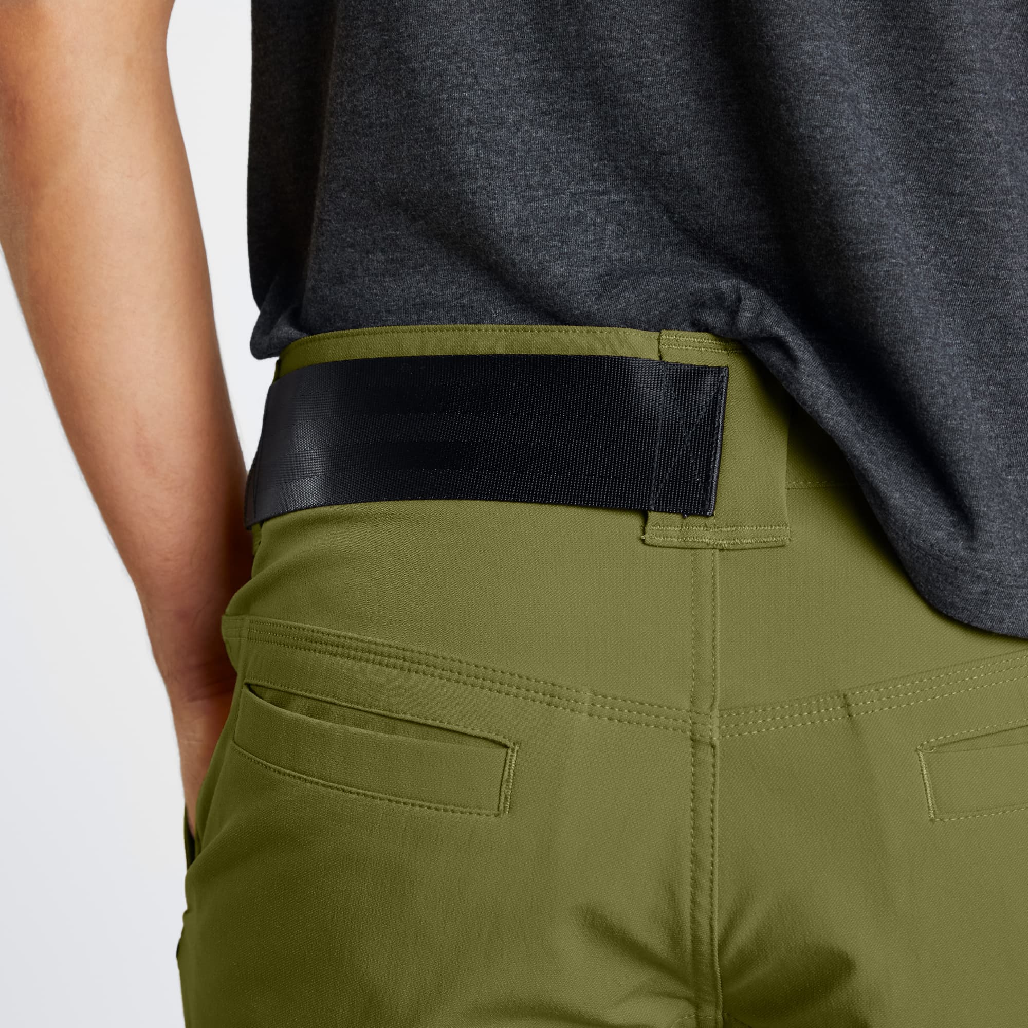 Men's tech Folsom Mid Short in green worn by a man waist detail #color_olive branch