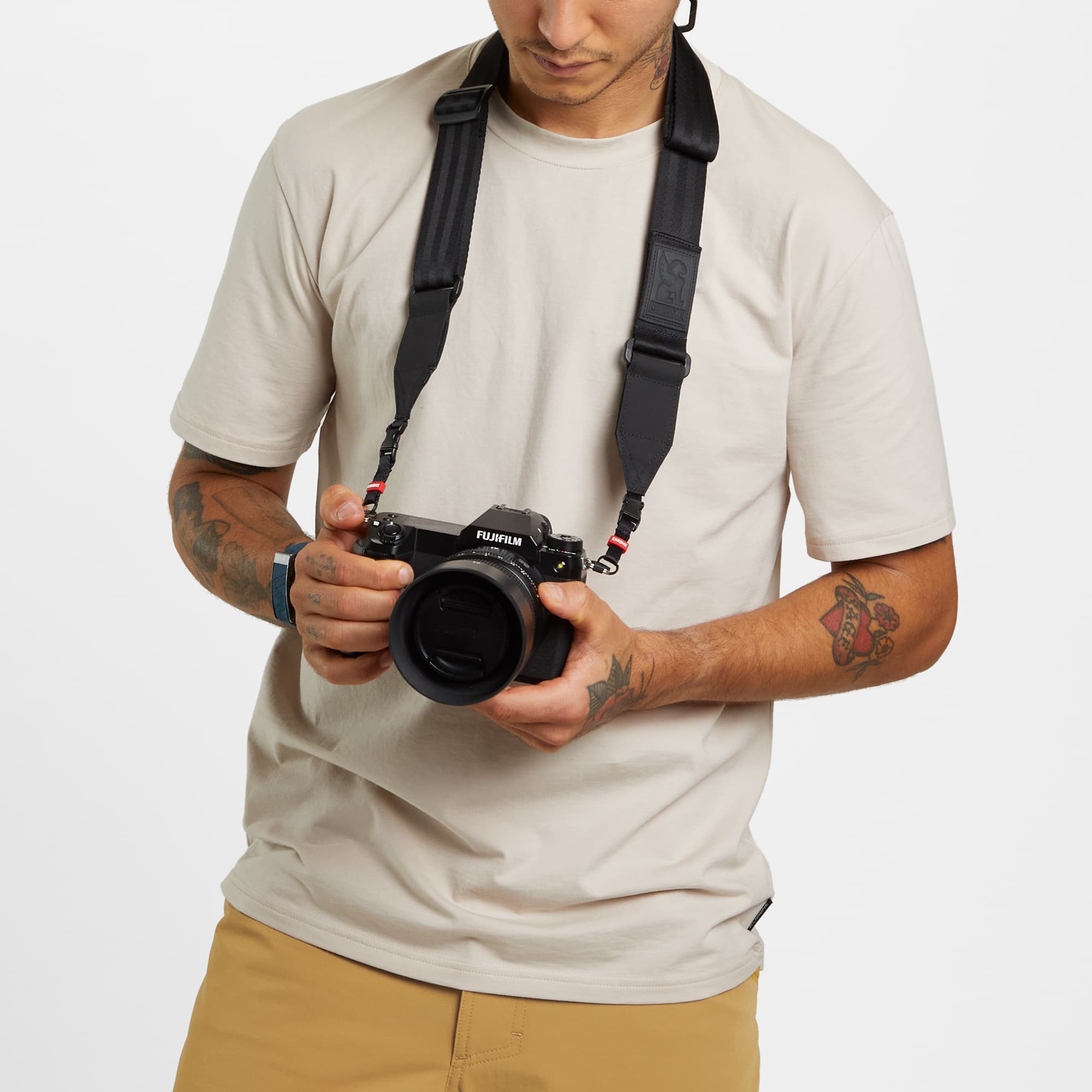 Niko Camera Shoulder Strap on a man with camera #color_black
