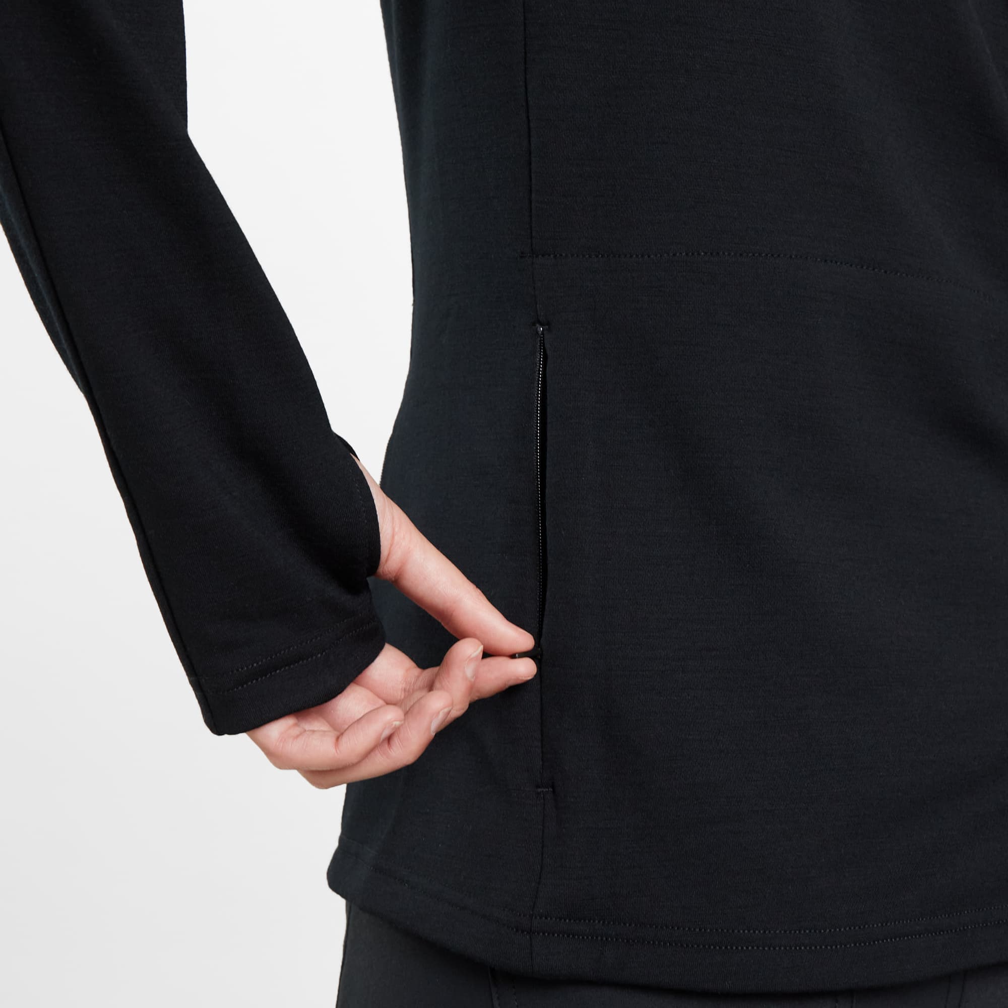 Women's Merino blend performance hoodie in black worn by a woman back zipper view