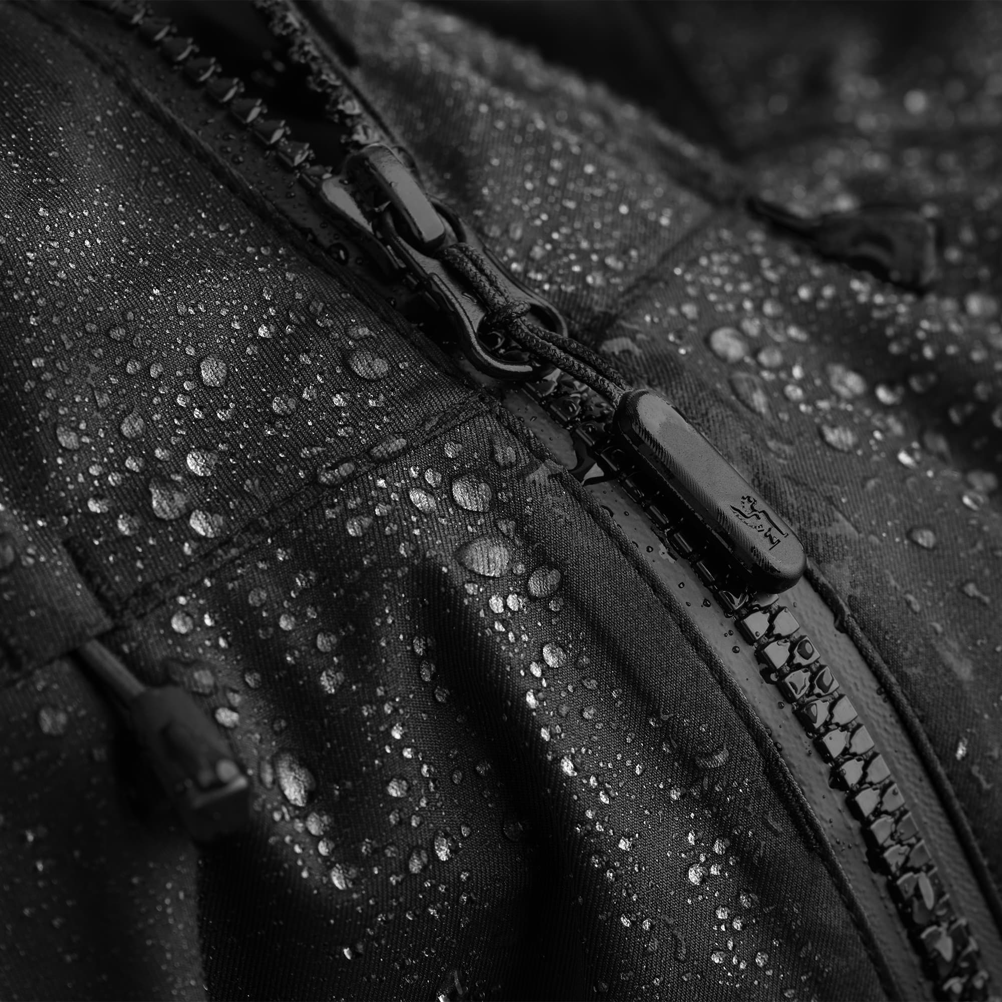 Waterproof rain jacket in black water beading off