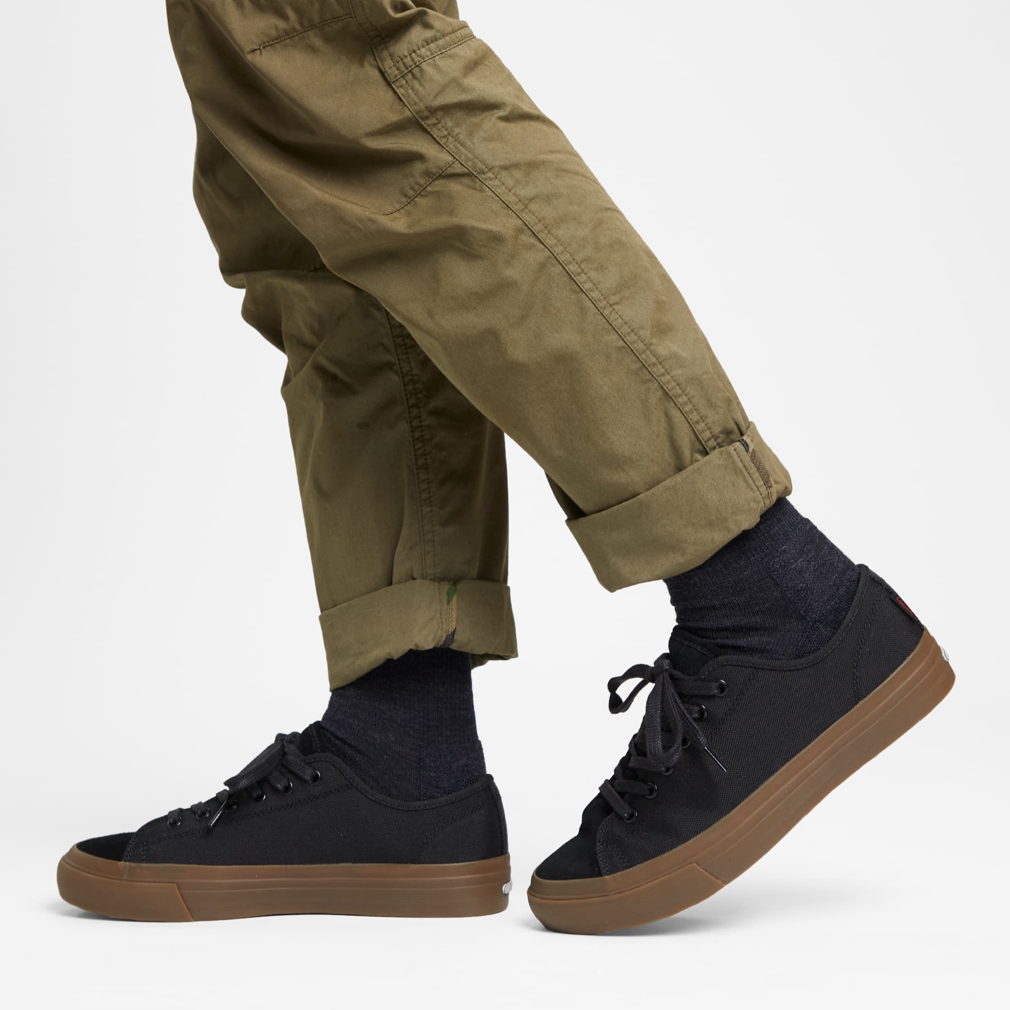 Kursk all weather sneaker in black gum worn by a man #color_black / gum