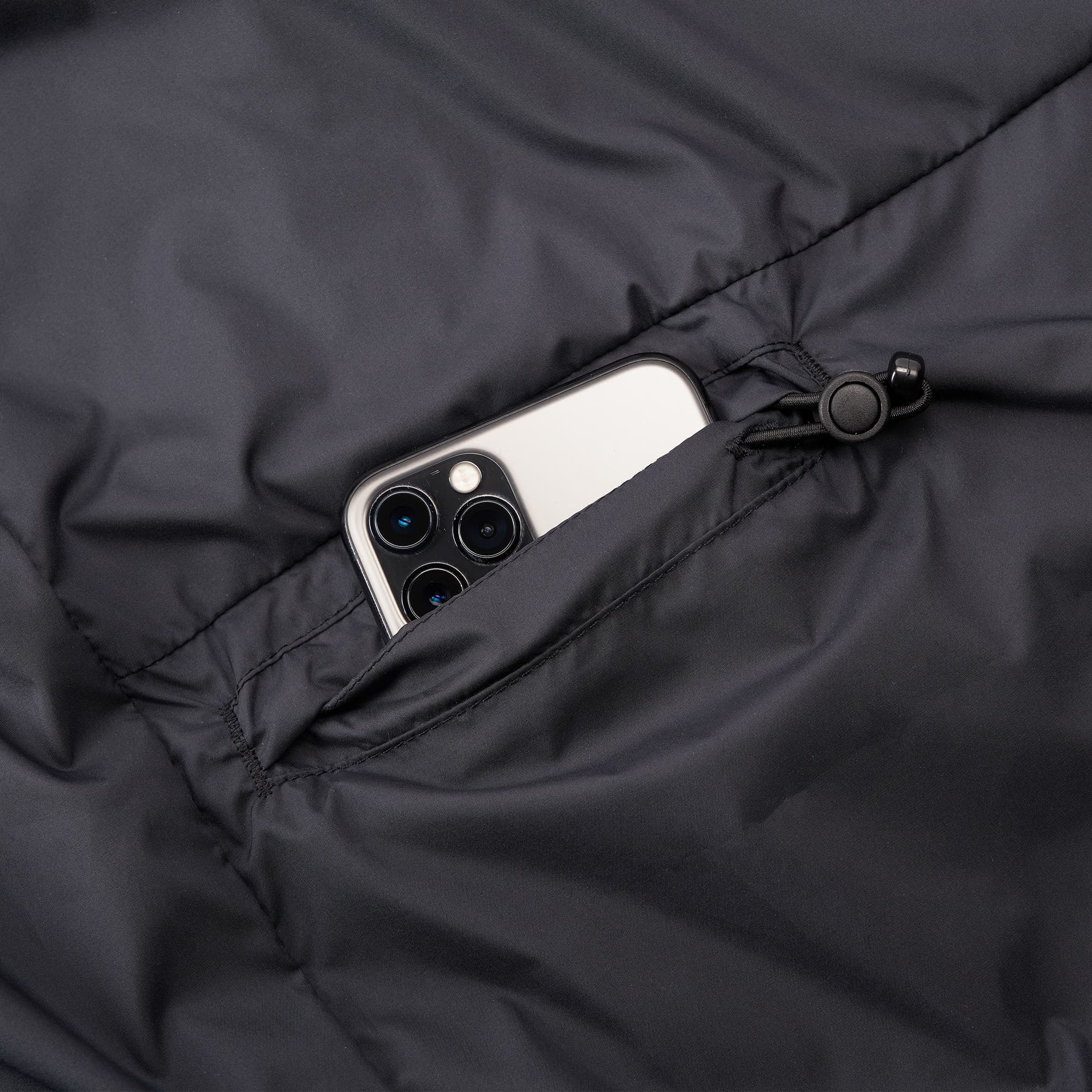 Lightweight packable wind breaker in black pocket detail