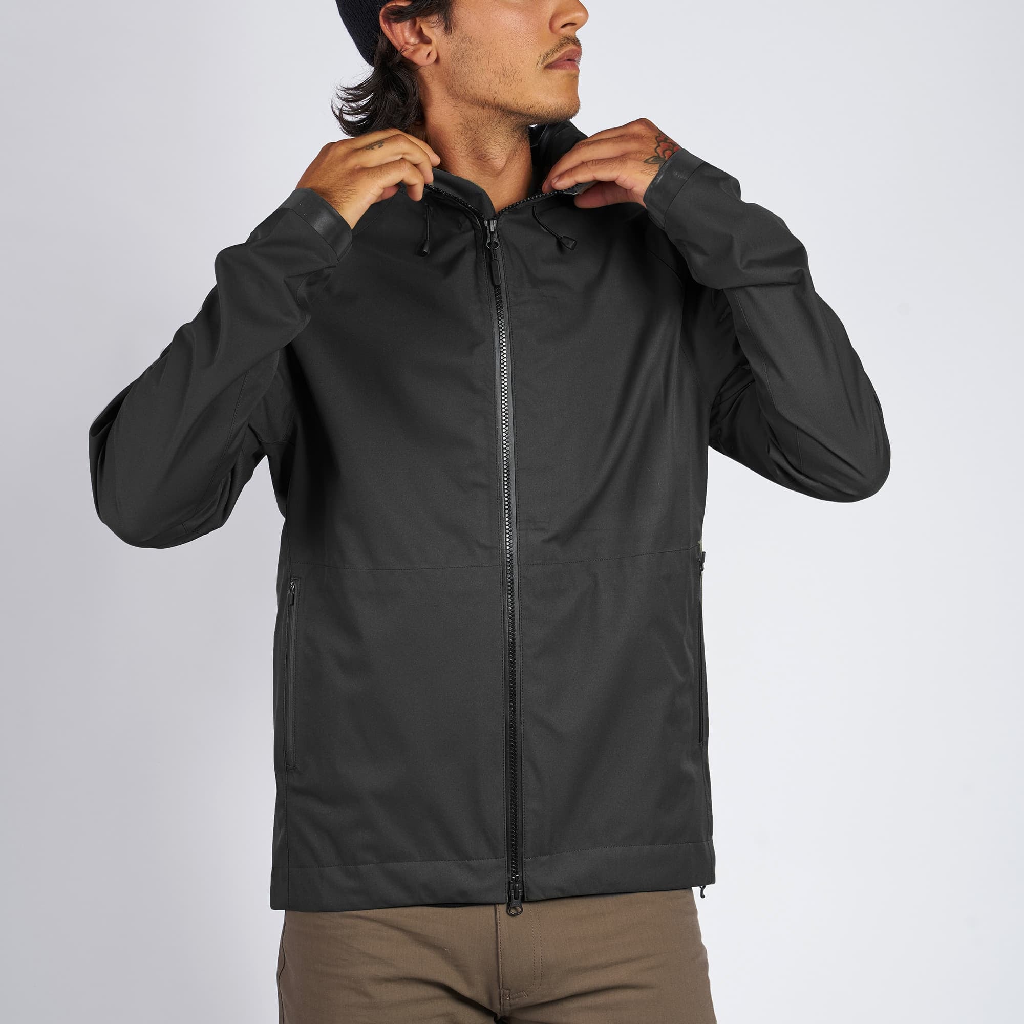 Waterproof rain jacket in black worn by a man front view