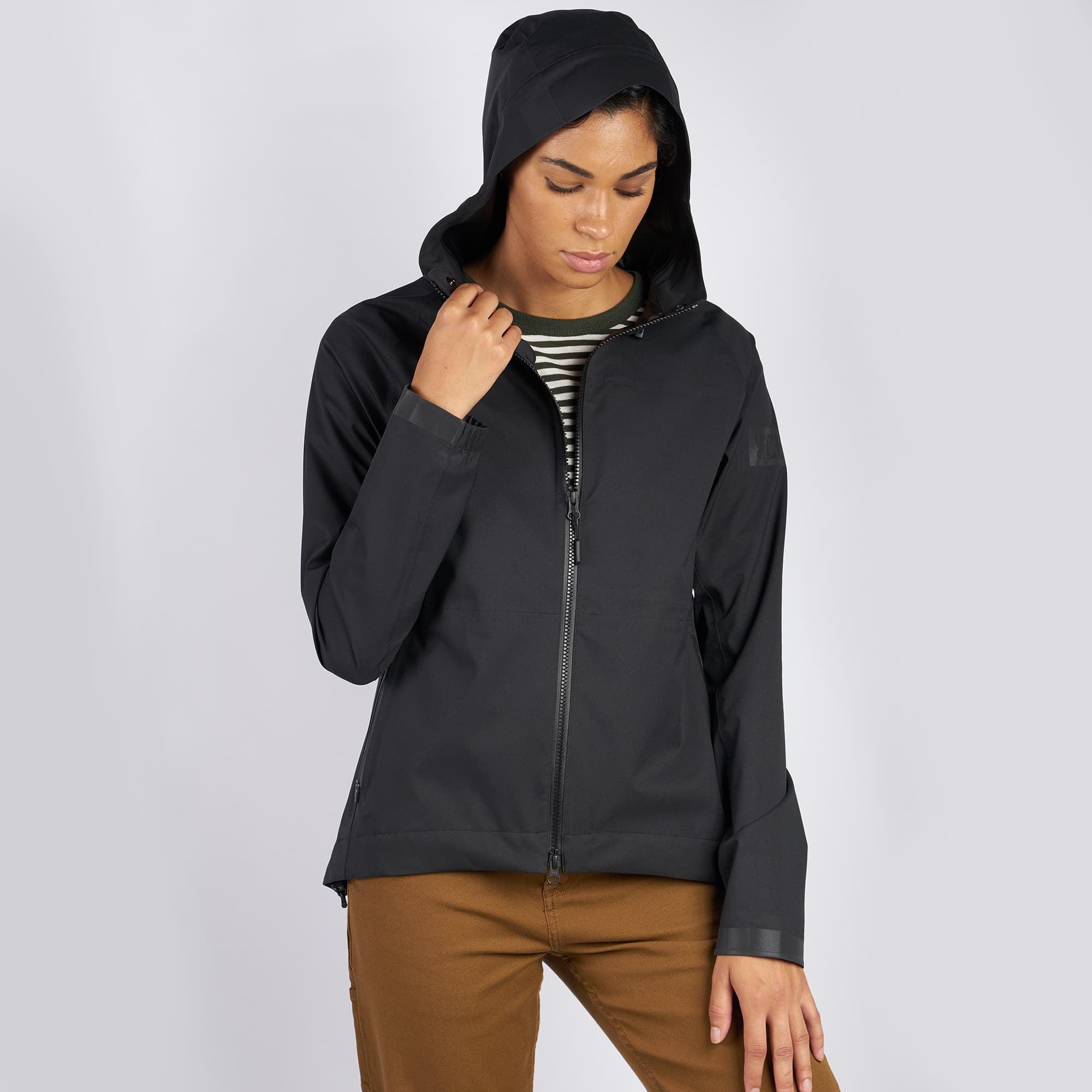 Women's waterproof jacket in black worn by a woman full front view