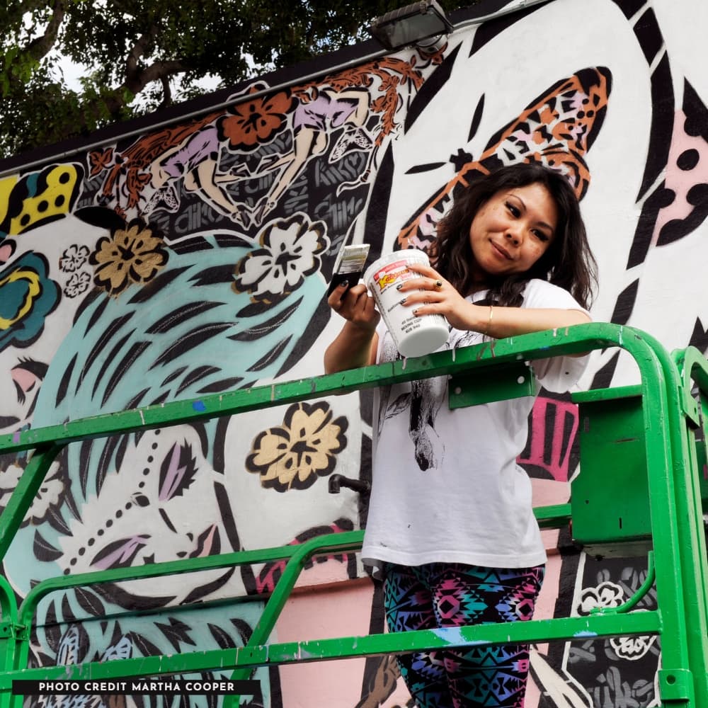 Lady Aiko painting a mural