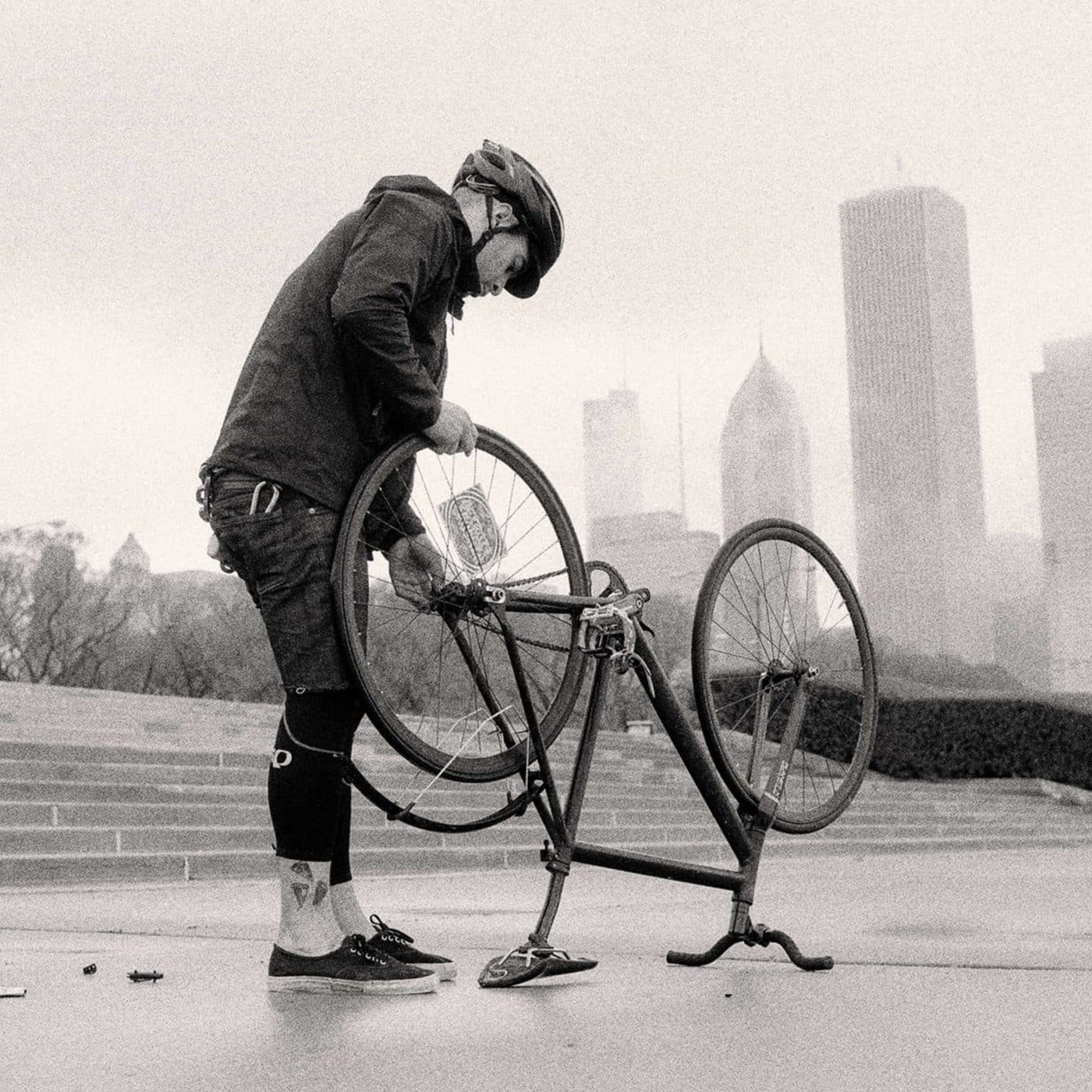 person fixing a bike tire