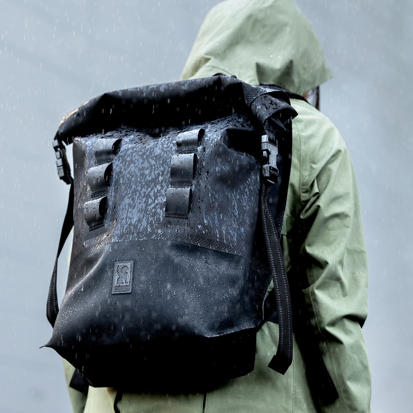person wearing waterproof urban ex backpack in the rain