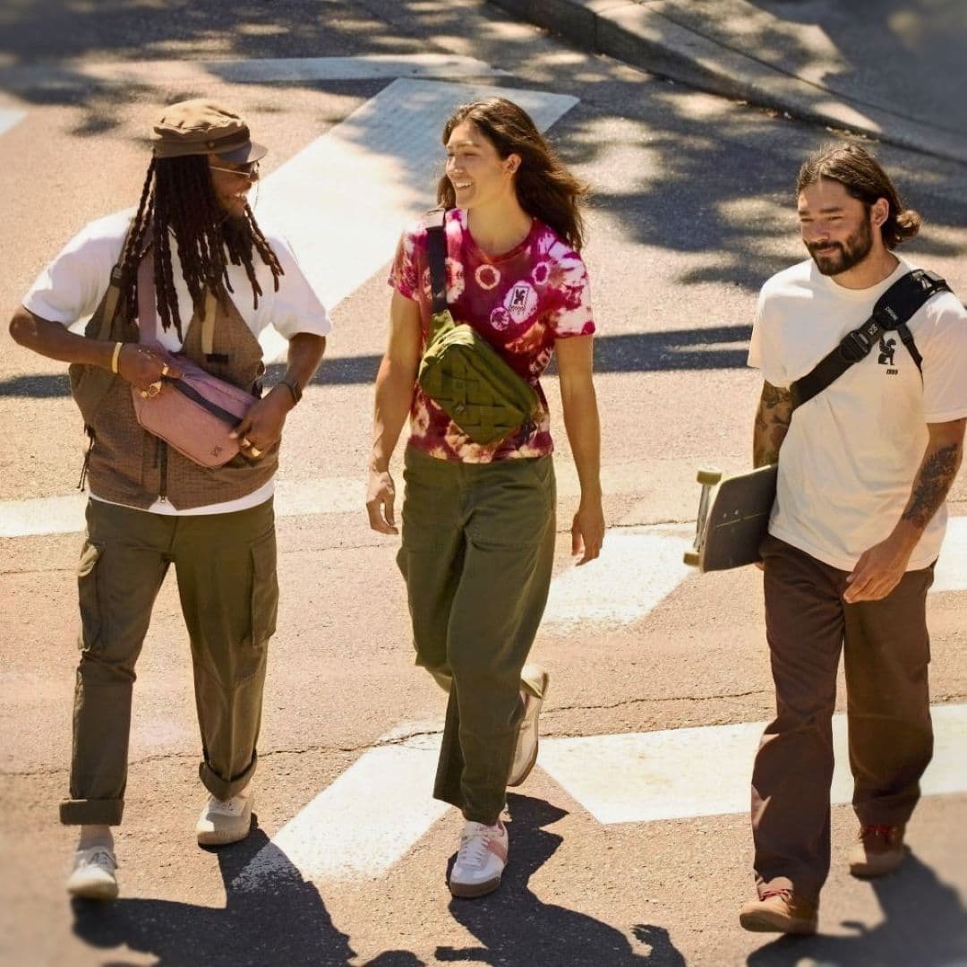 Three people crossing the street in Chrome Industries Sling bags