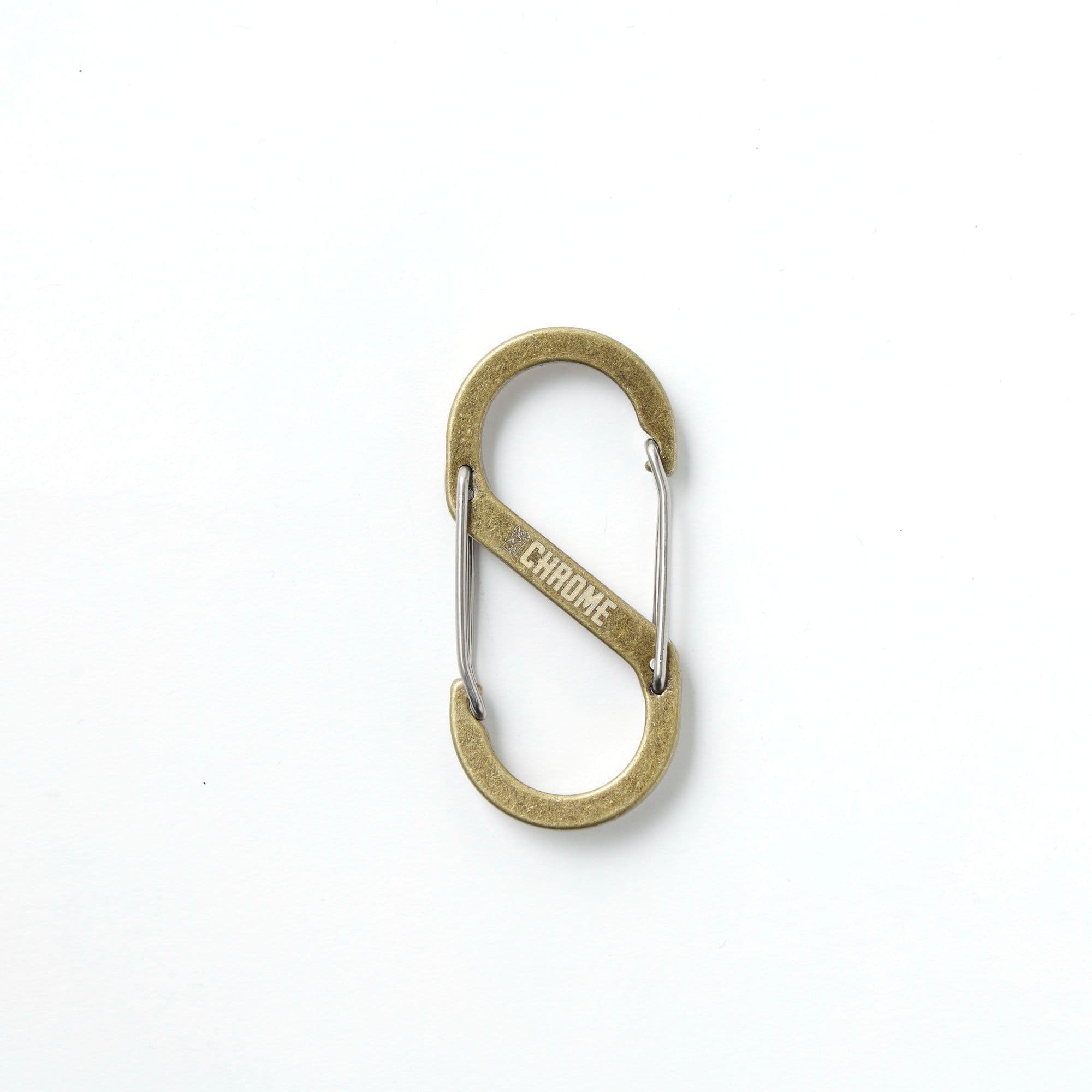 Brass color S-hook carabiner with Chrome Industries branding #color_brass