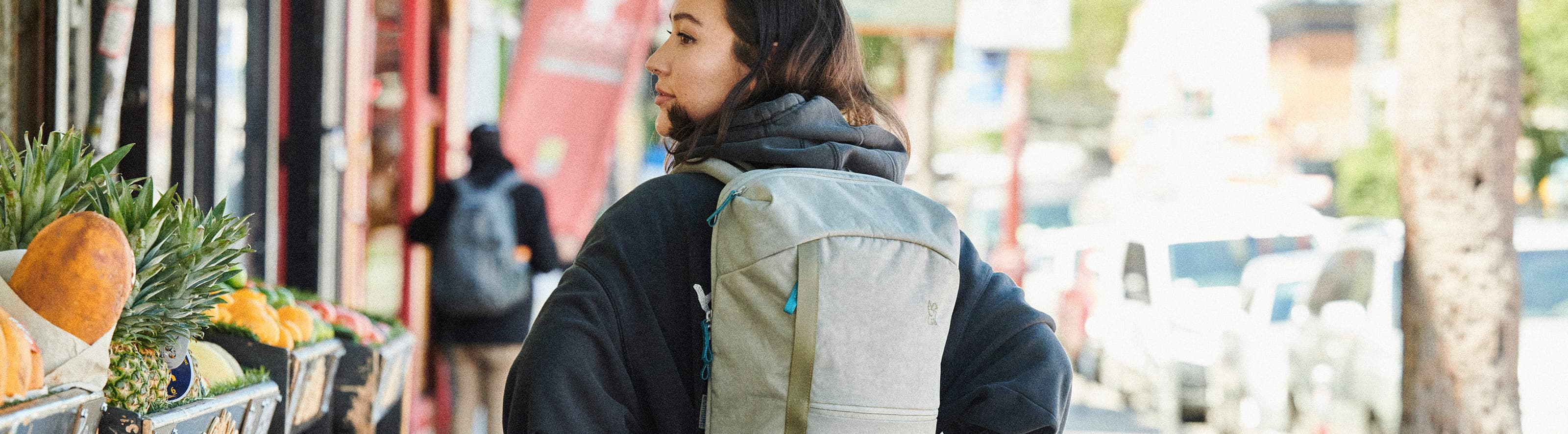 Woman walking wearing the Camden Backpack