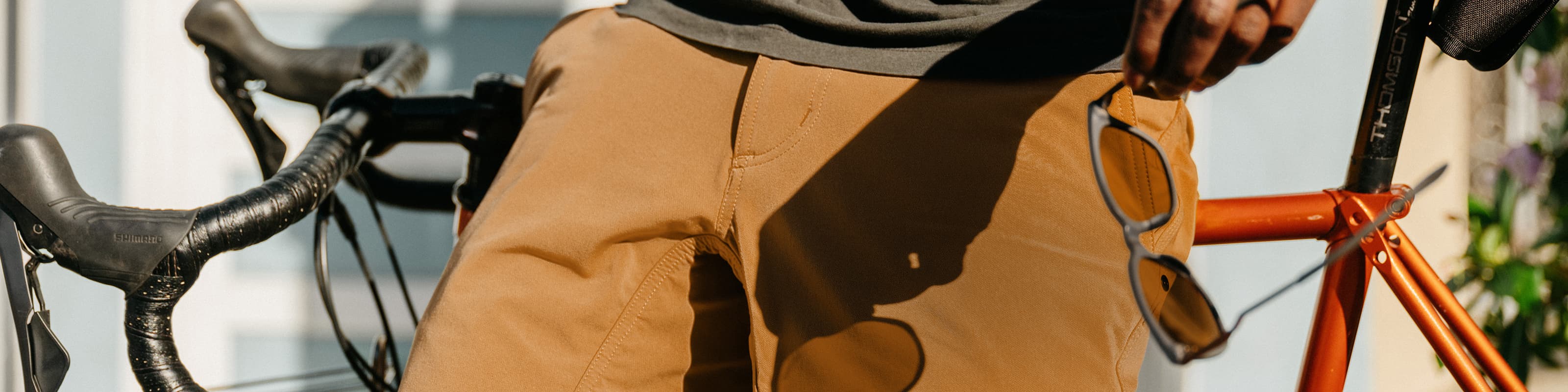 The Folsom Short in brown on a man leaning on a bike