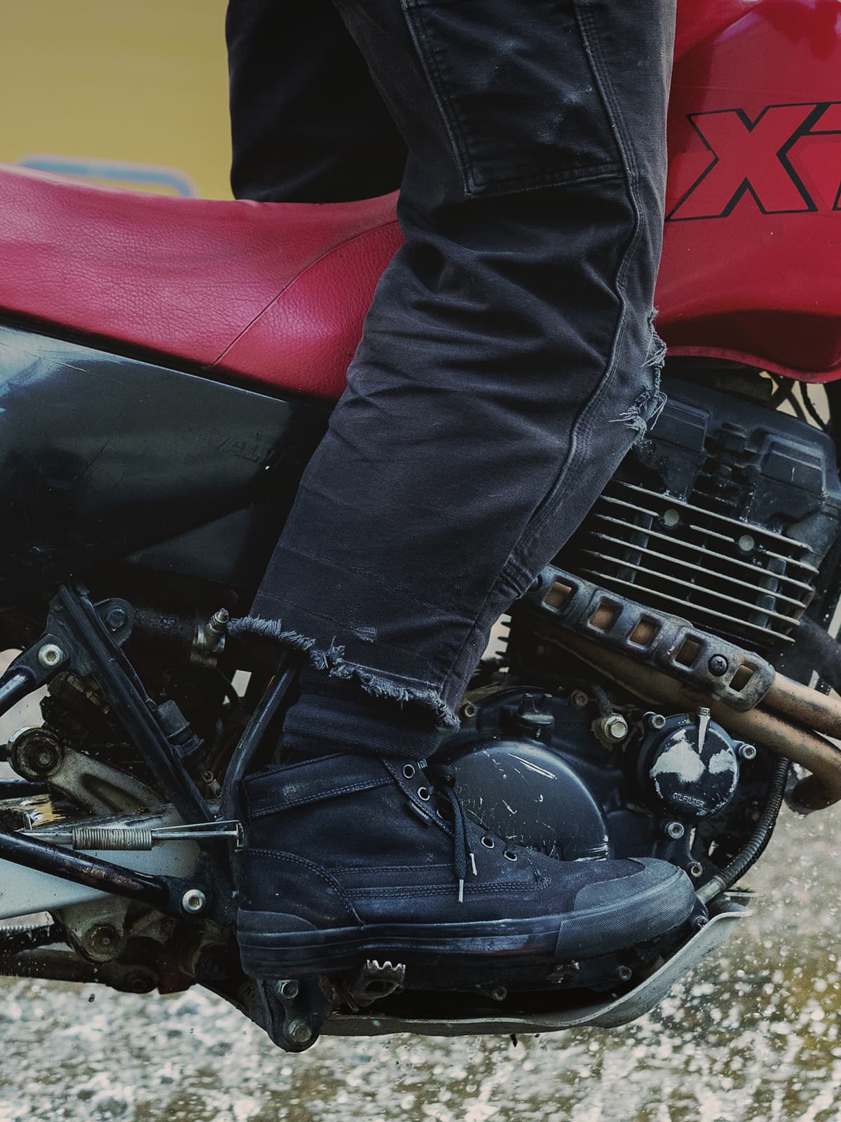 Chrome Industries 415 Boots in black worn by a person riding a red motorcycle.